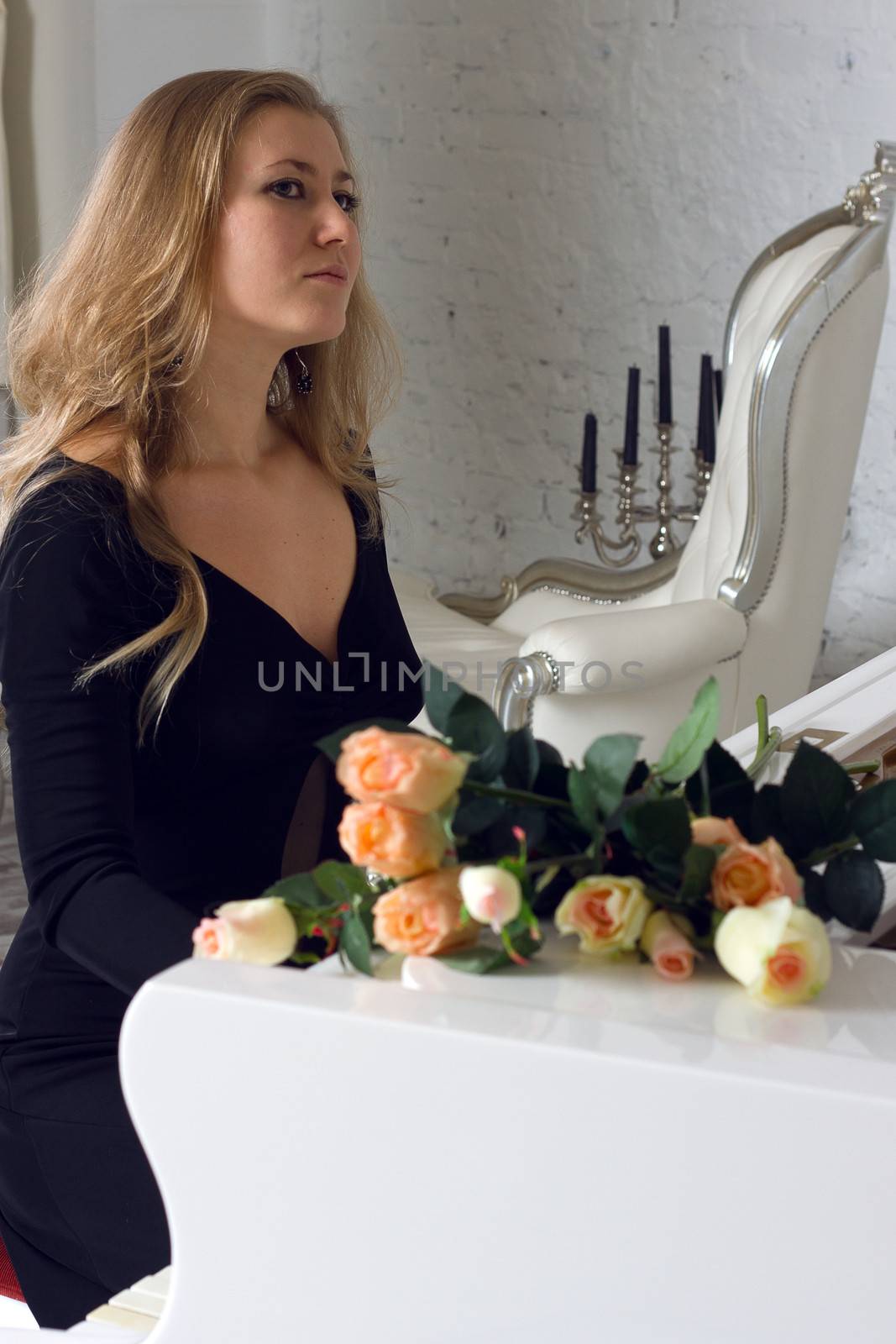 beautiful young woman playing the white piano