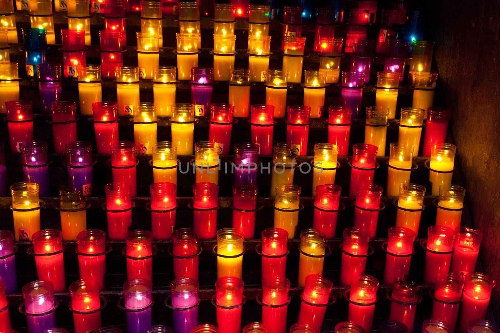 Church candles in red and yellow transparent chandeliers by elena_shchipkova