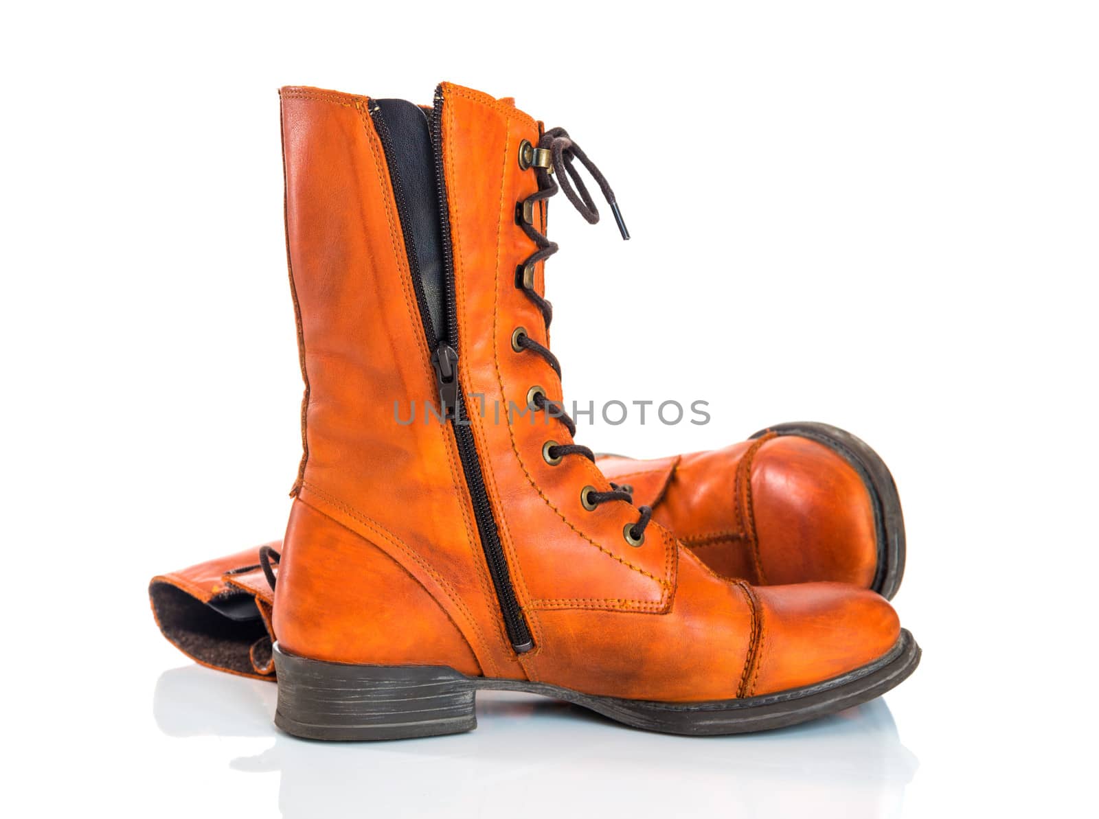 Stylish orange leather boots, isolated on white background.