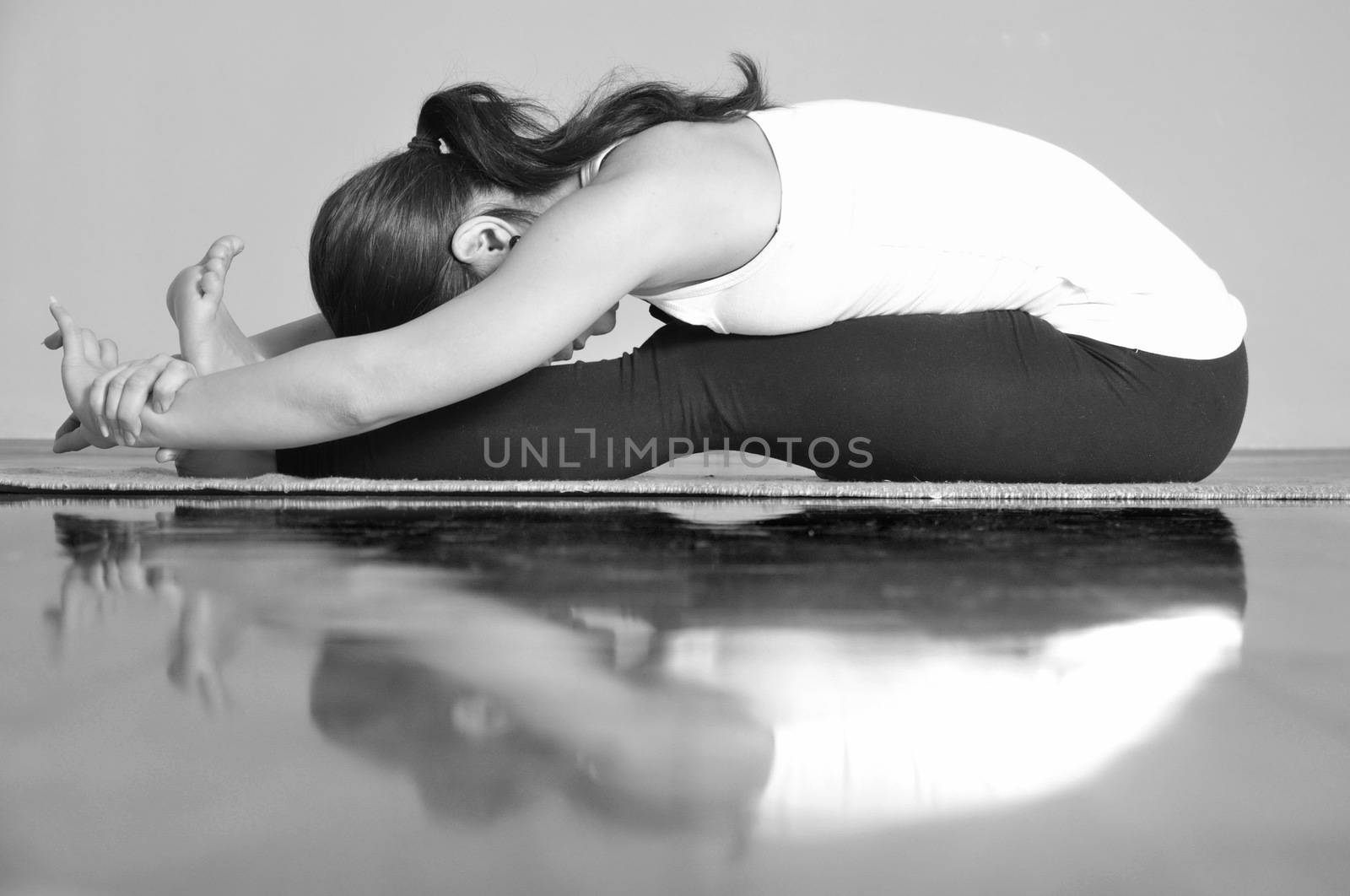 Girl doing Paschimottanasana yoga pose by anderm