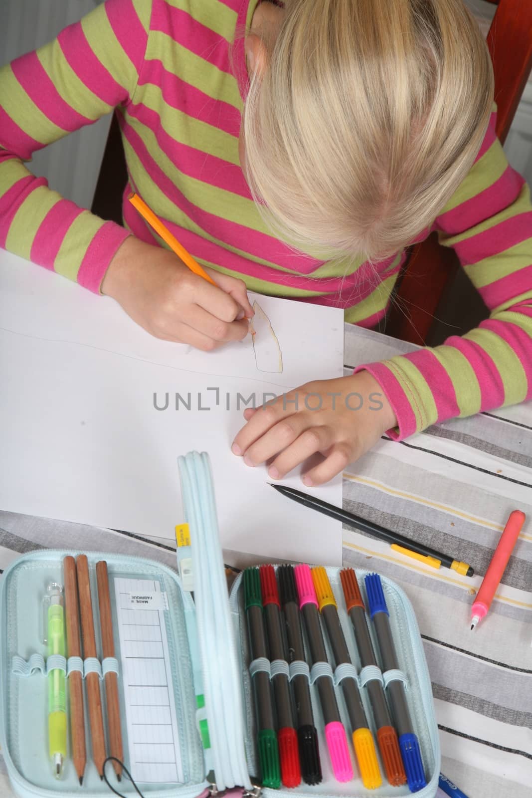 young child writting , painting and playing with colours (chinese child)