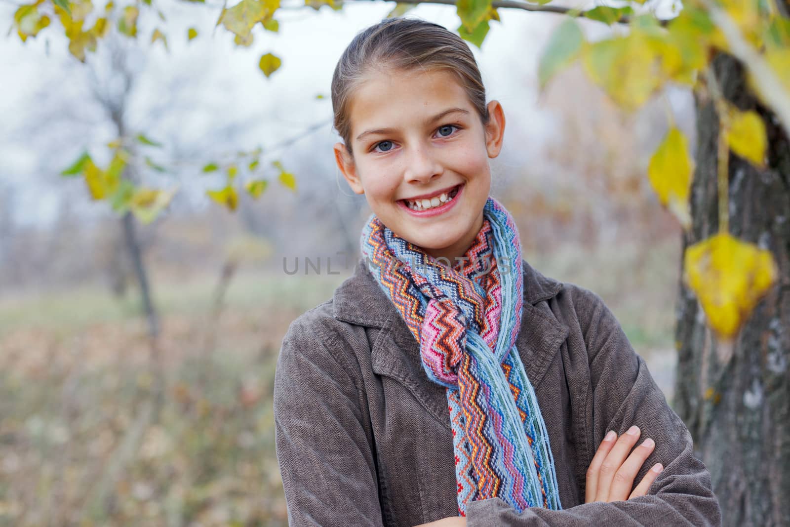 Portrait of beautiful girl walking in a autumn park