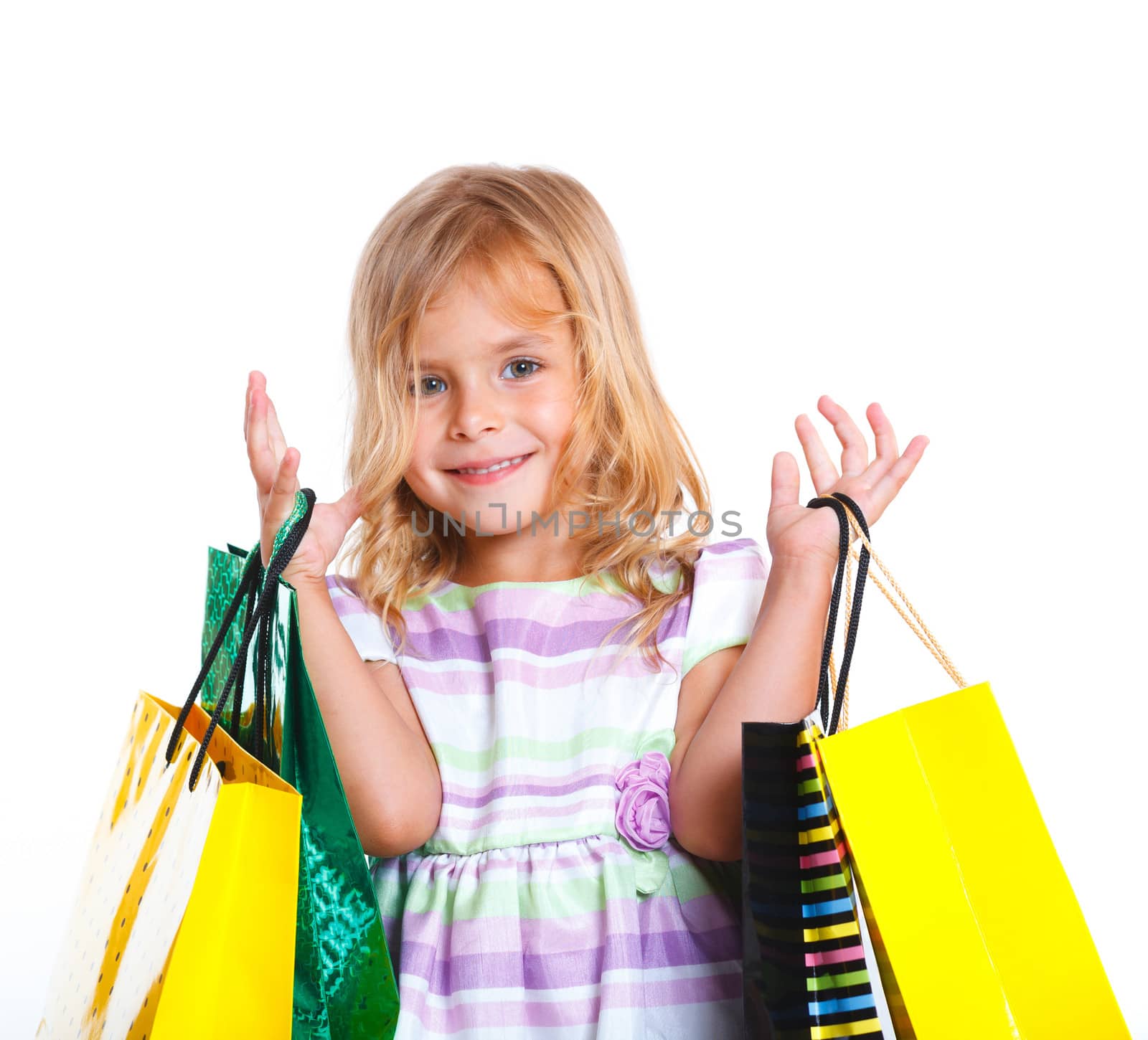 Shopping little girl happy smiling holding shopping bags isolated on white background.