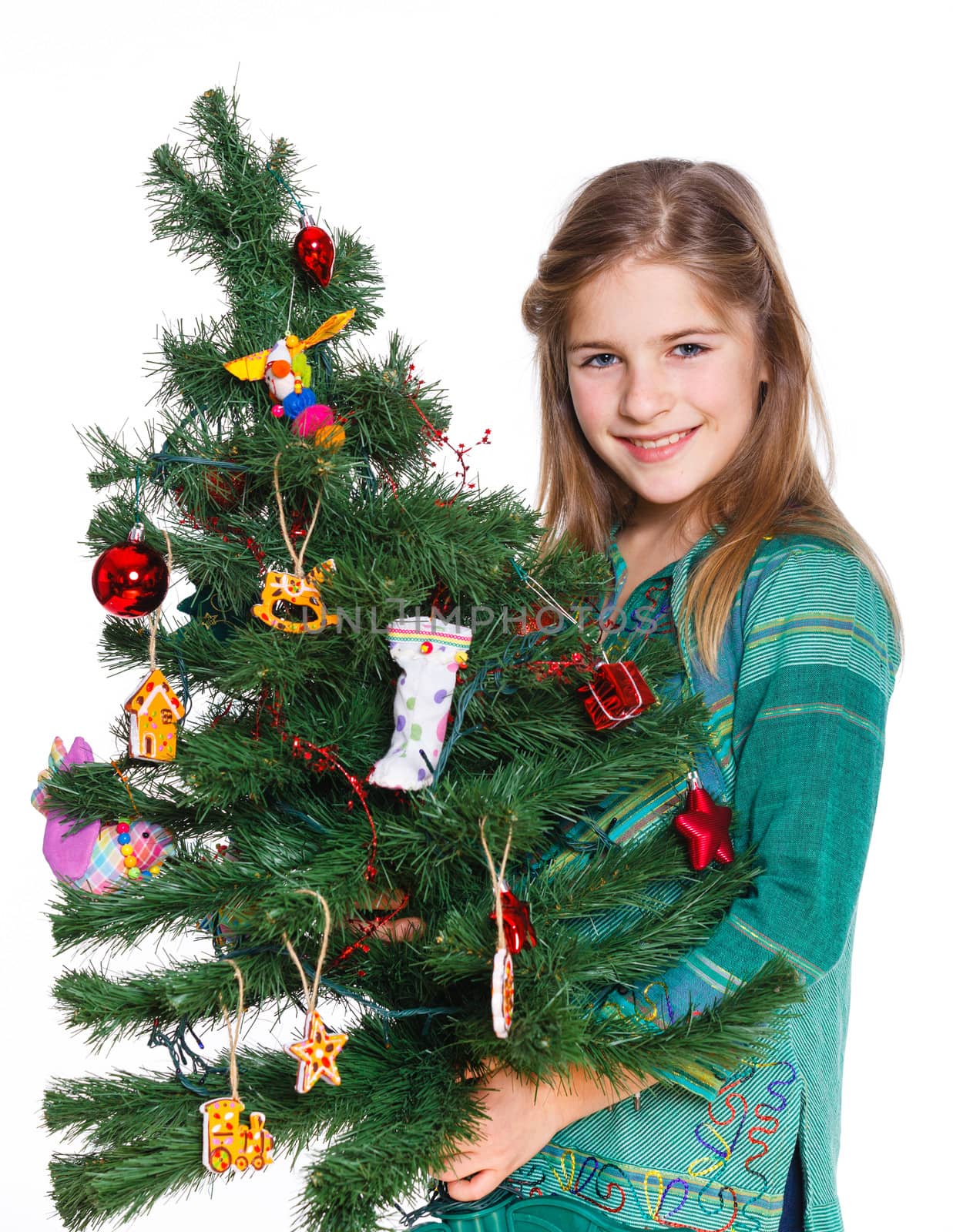 Christmas theme - Beautiful girl decorating christmas tree. Isolated on white backround.