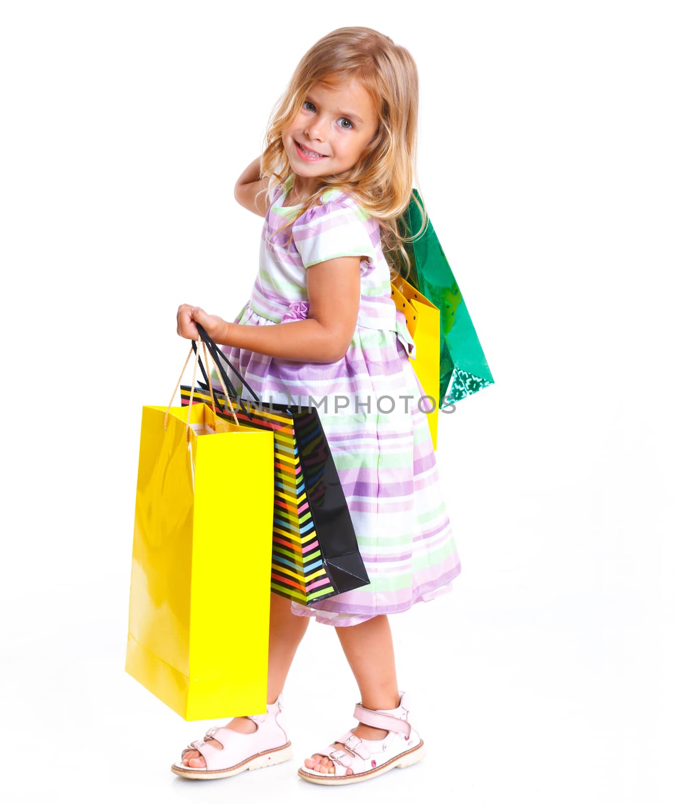 Shopping little girl happy smiling holding shopping bags isolated on white background.