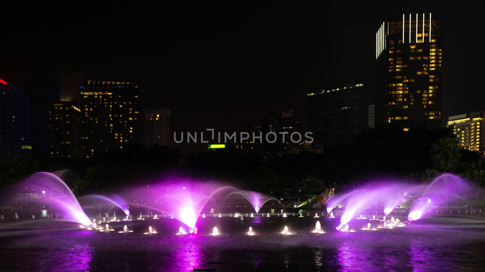 Illuminated fountain at night in modern city by iryna_rasko