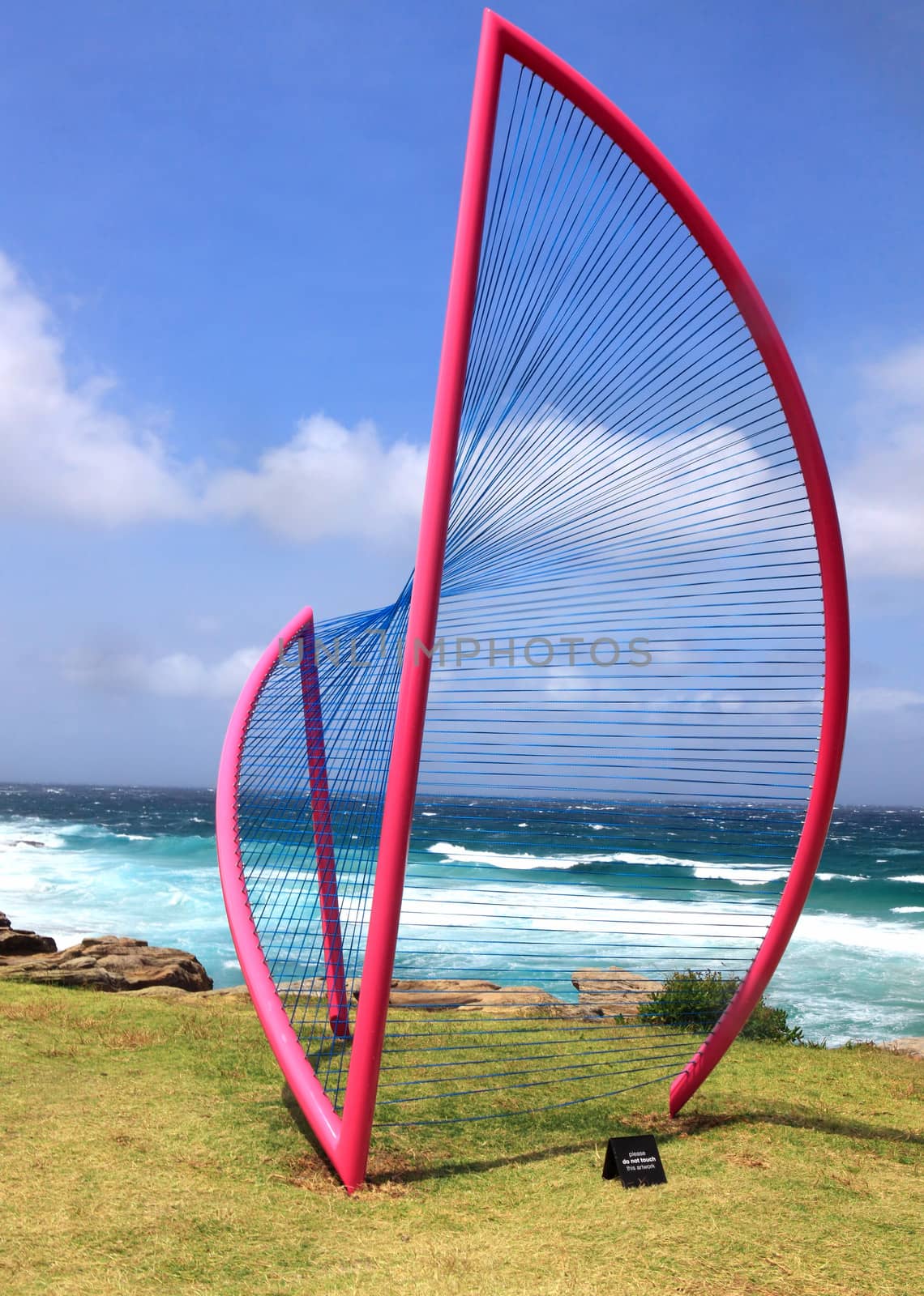 BONDI BEACH, AUSTRALIA - OCTOBER 29, 2013: Sculpture By The Sea, Bondi. Annual event showcases artists around the world  Sculpture titled 'Inclusion' by Greer Taylor (NSW).  Medium aluminium, spectra cable, automotive paint, nickel painted brass