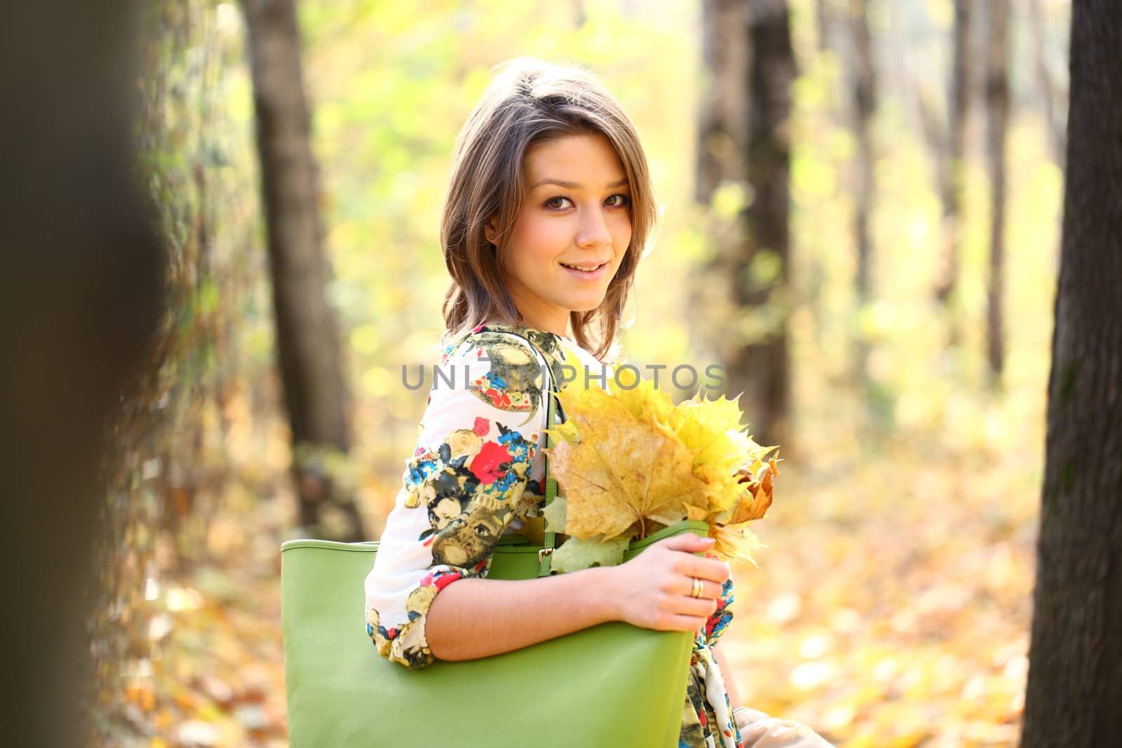 Beautiful young woman in autumn park