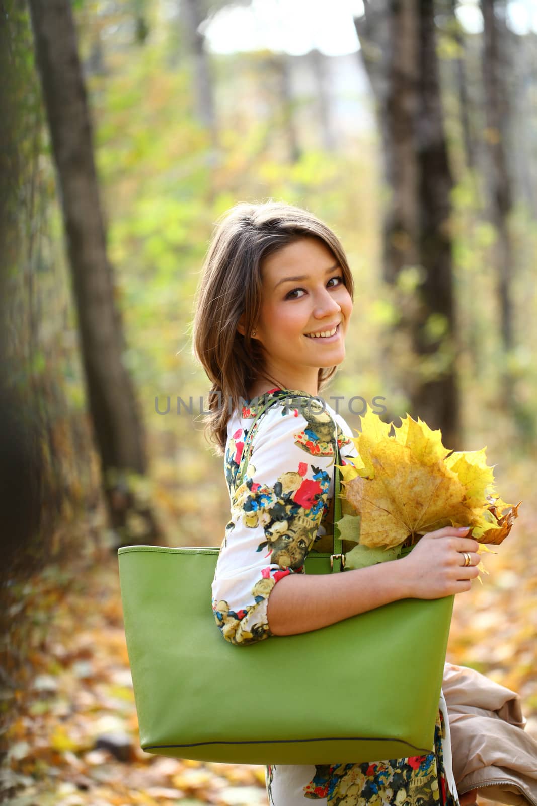 Beautiful young woman in autumn park