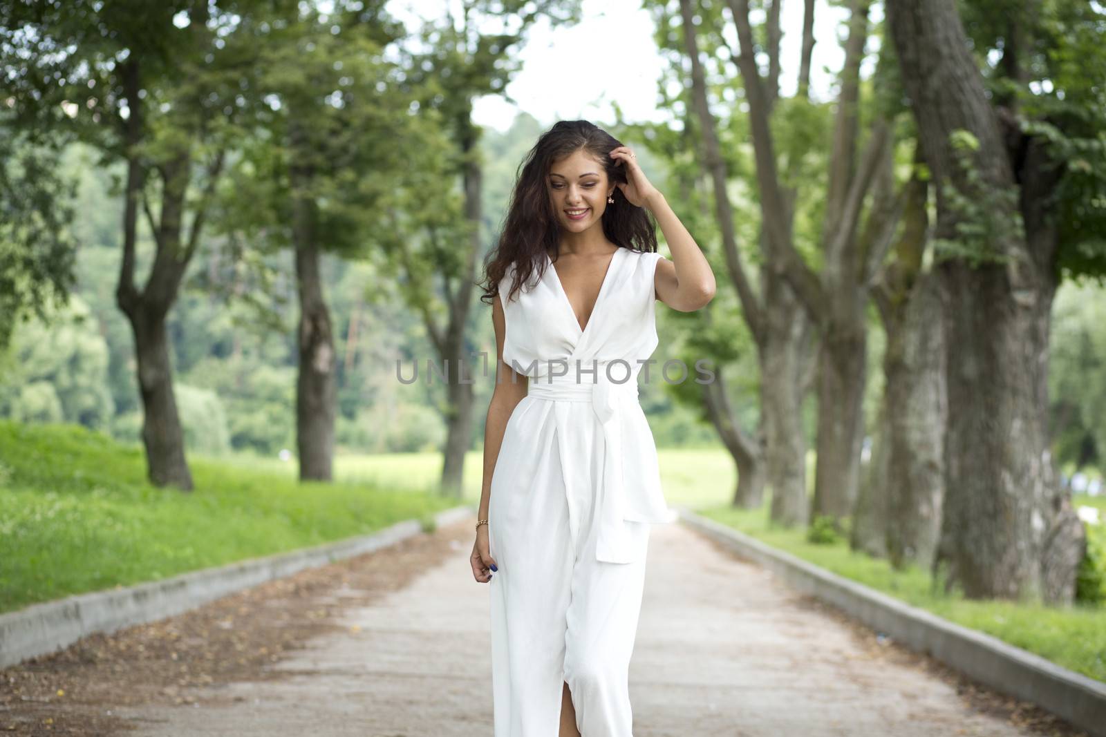 Happy woman in a white dress on the street