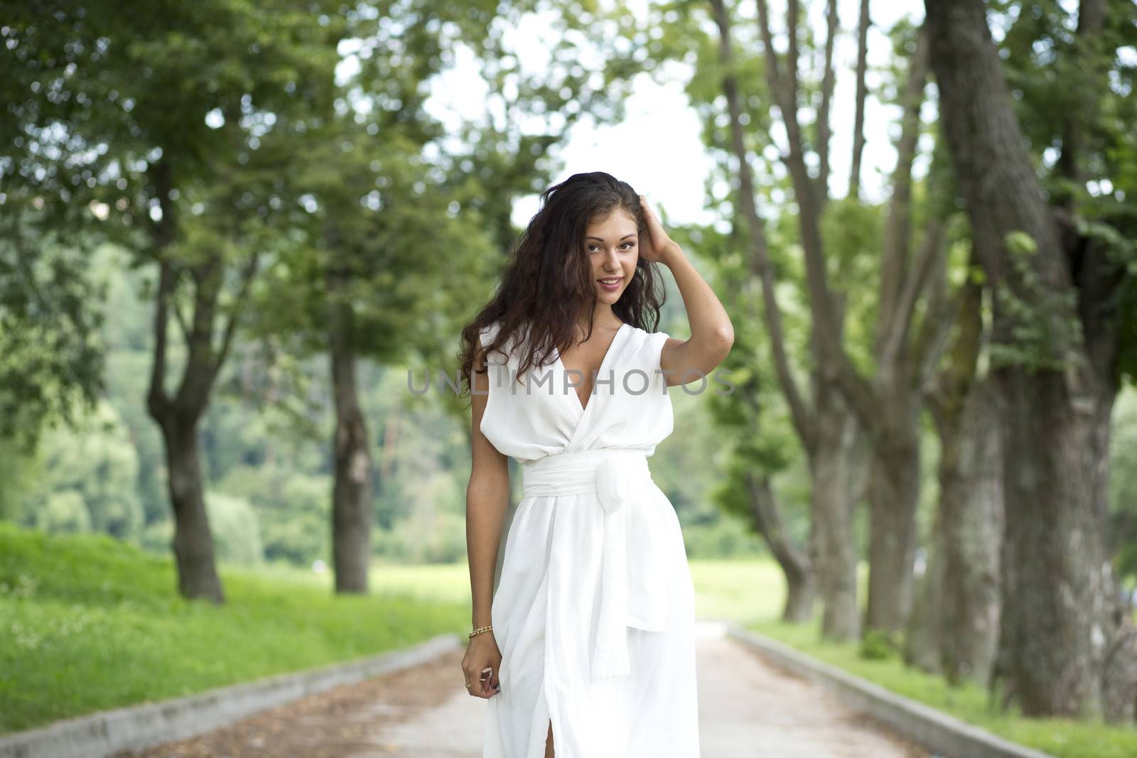Happy woman in a white dress on the street