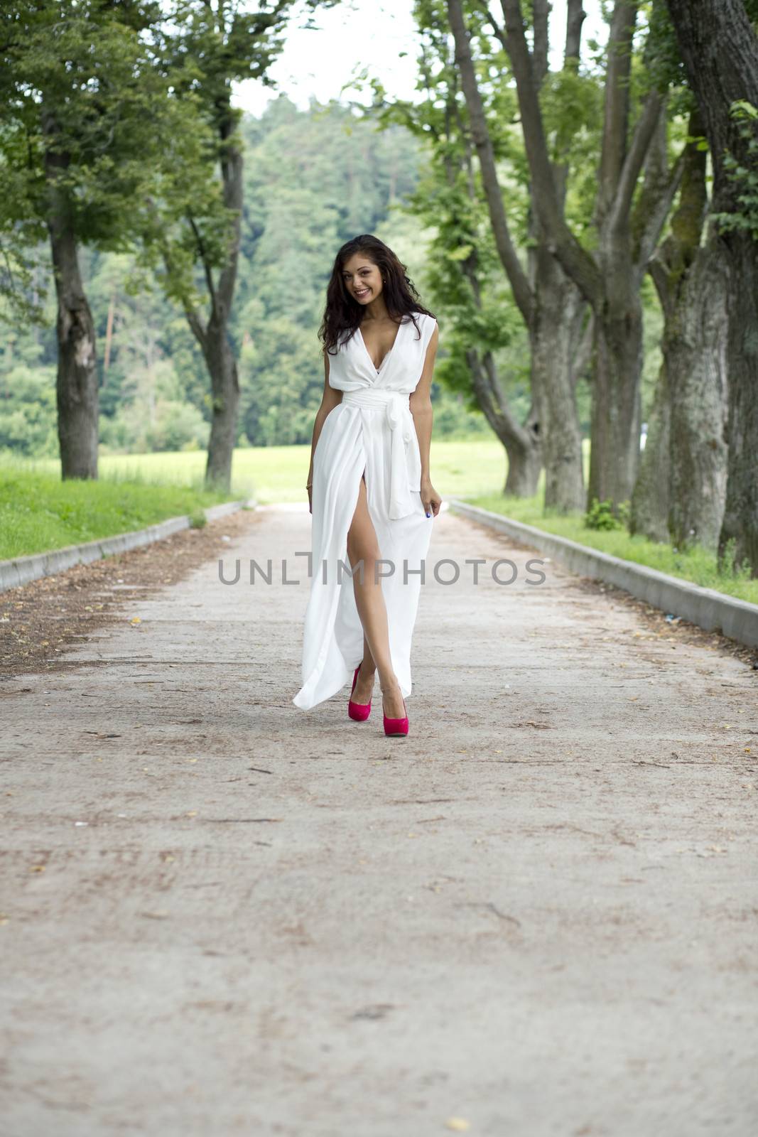 Happy woman in a white dress on the street
