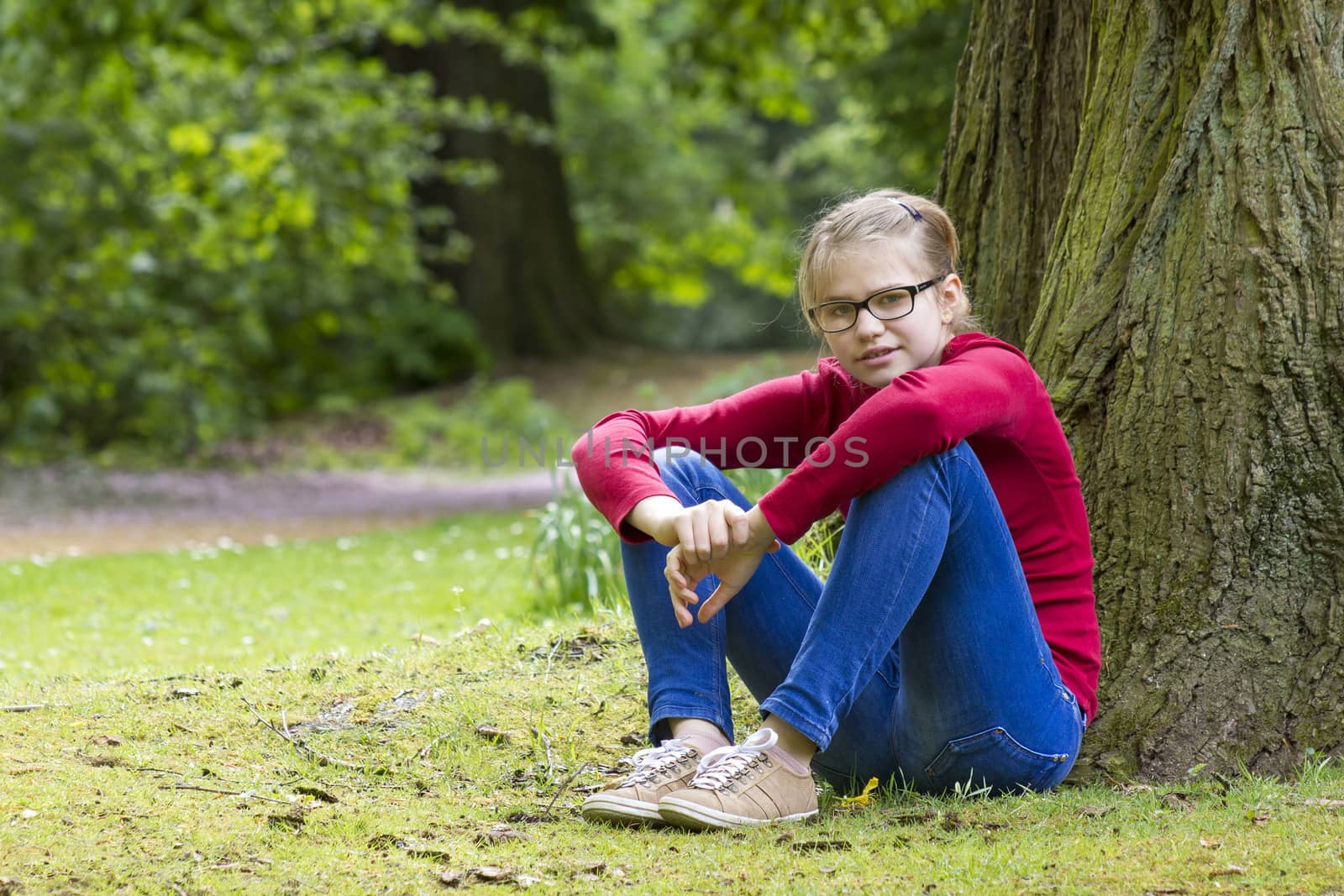 Young girl resting in park in spring day