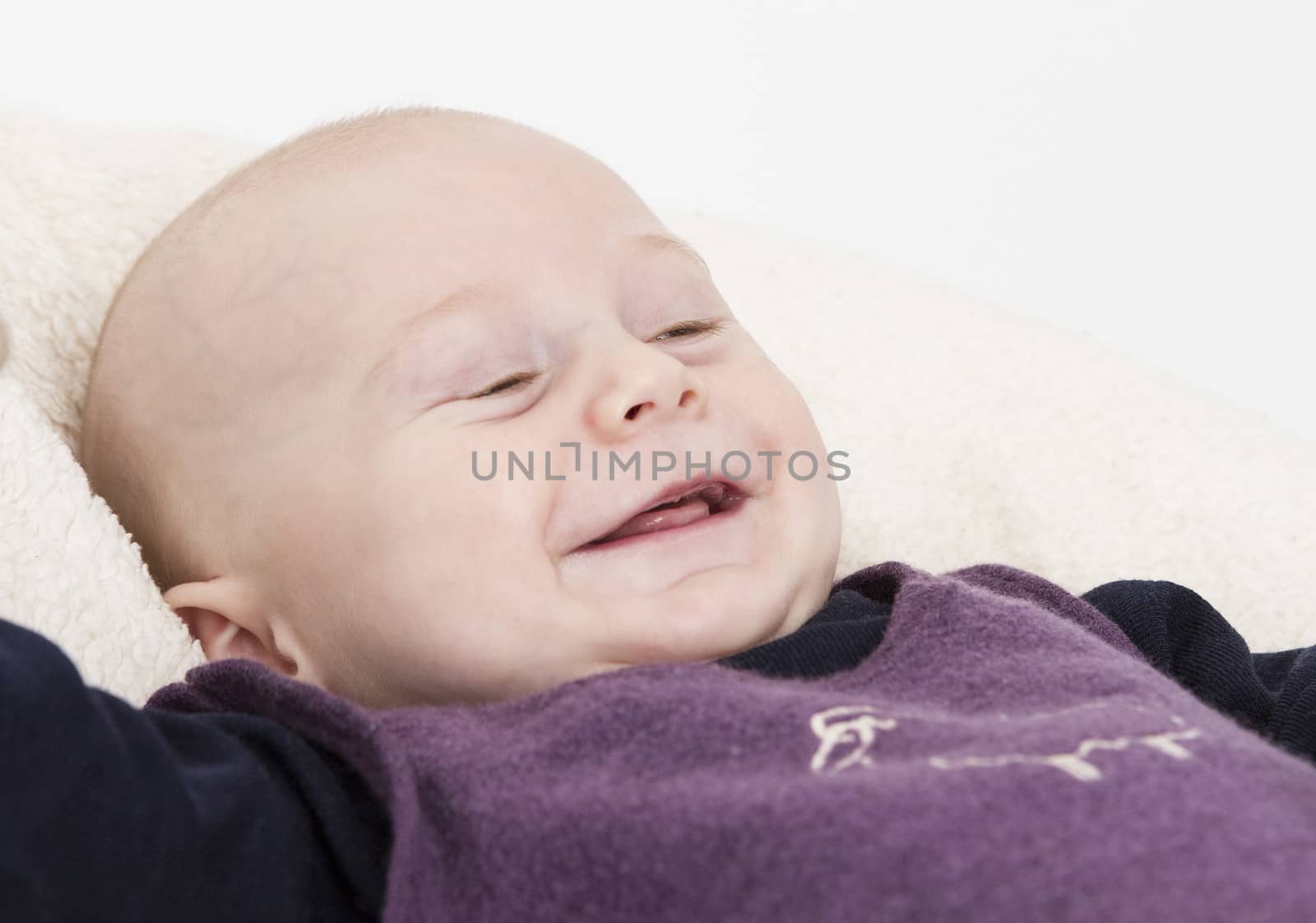 smiling young child in light background. horizontal image