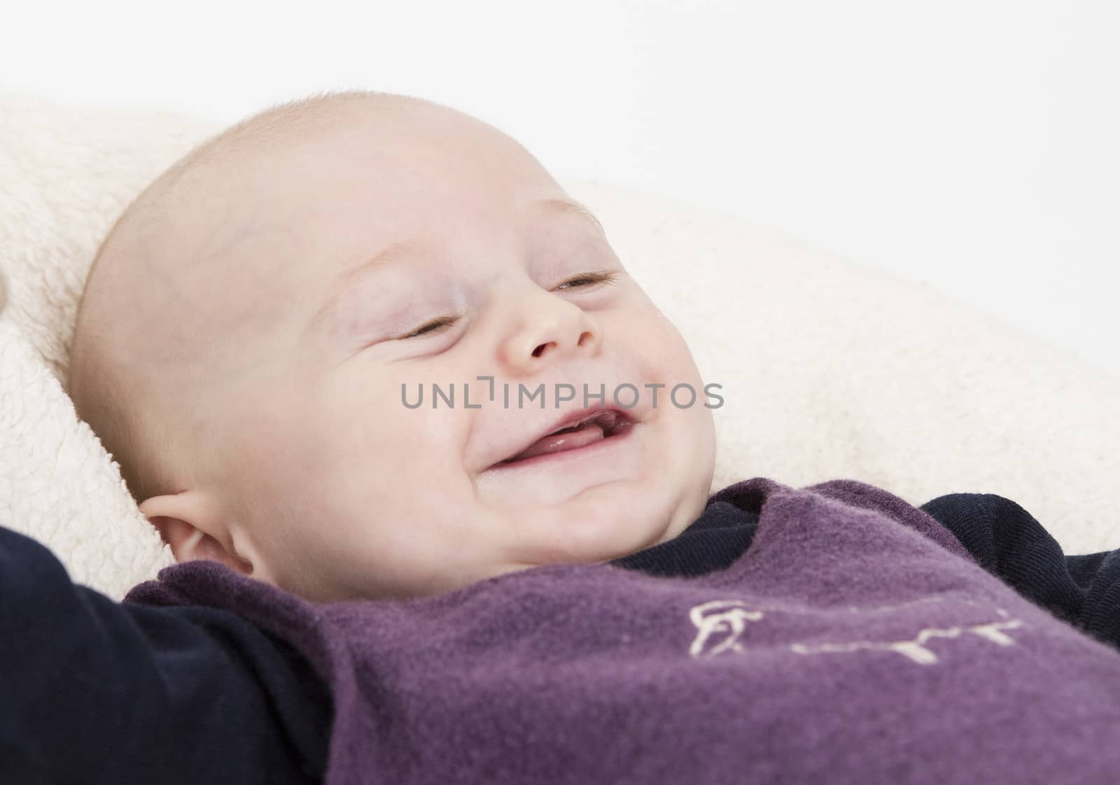 smiling young child in light background by gewoldi