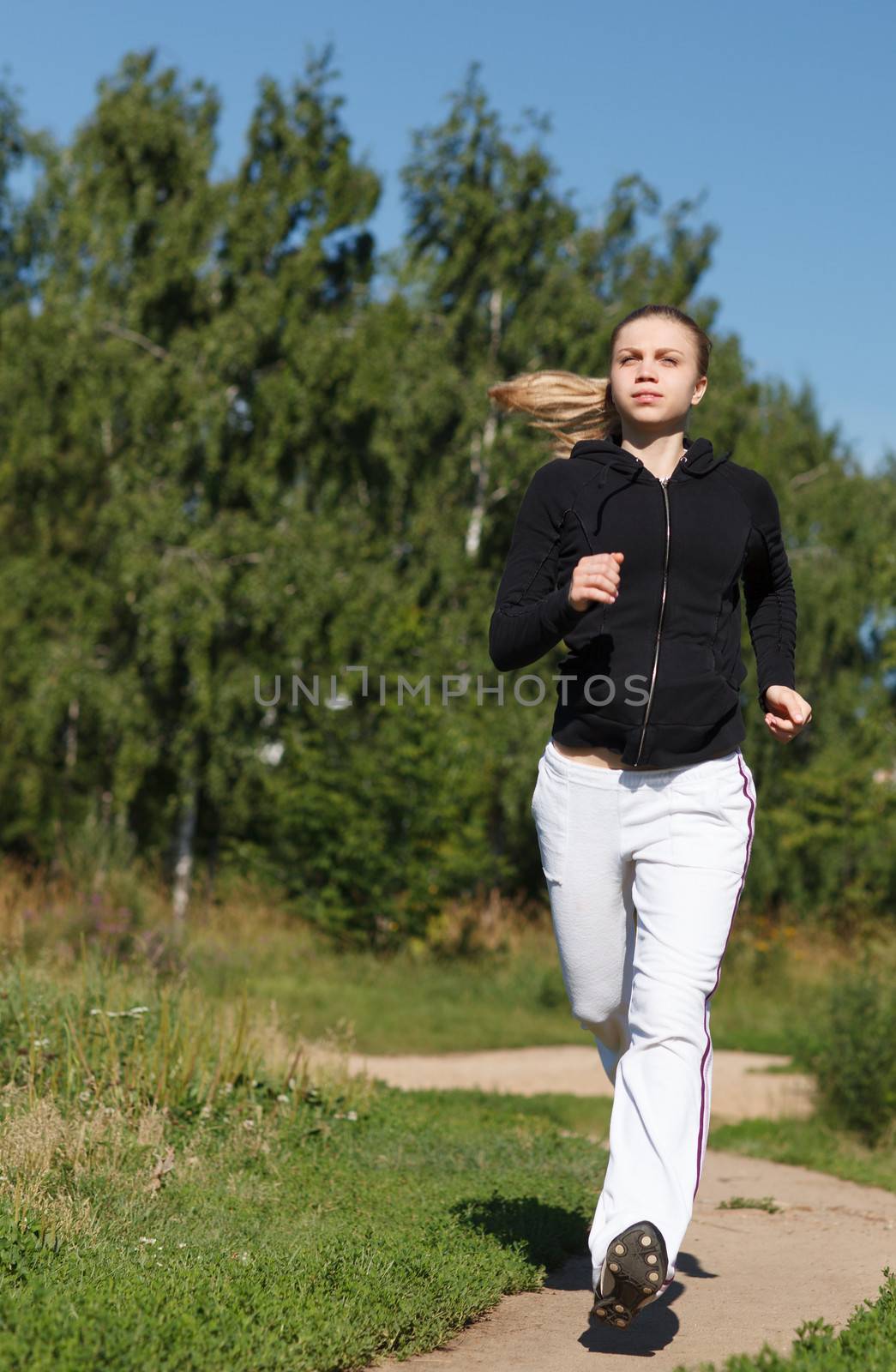 Girl running in the park. Wide shot by danr13