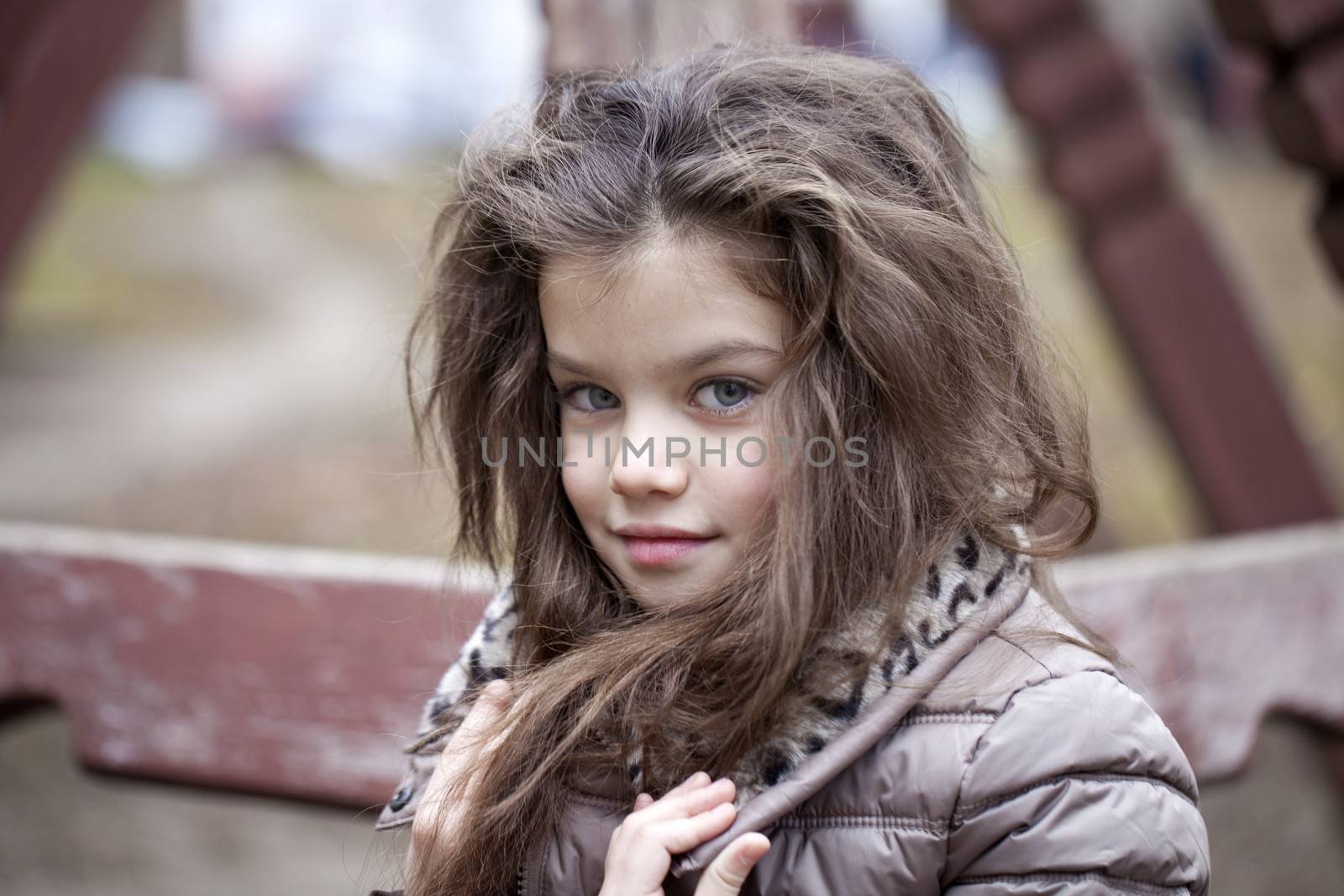 Autumn portrait of a beautiful young girl on the street