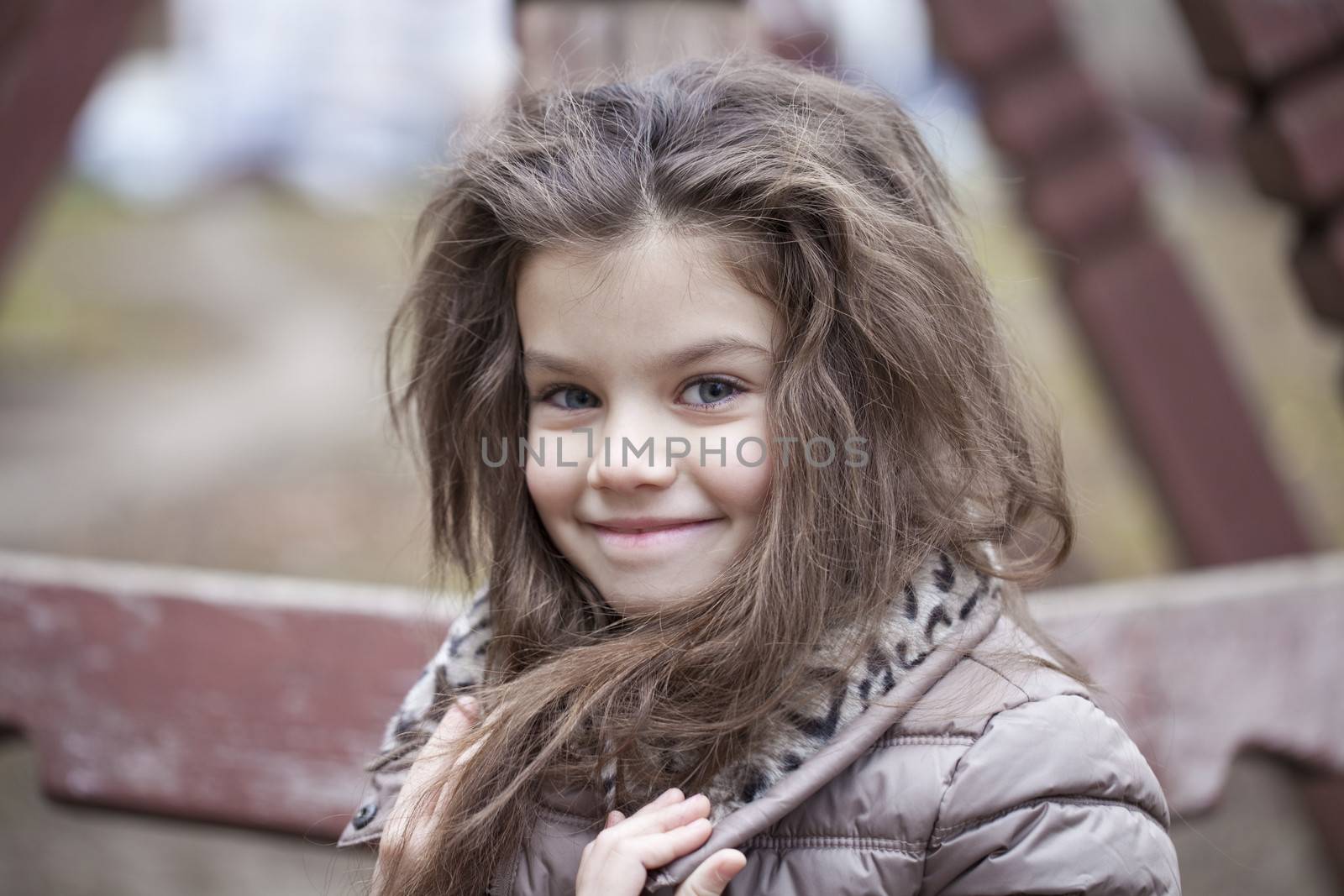 Autumn portrait of a beautiful young girl on the street