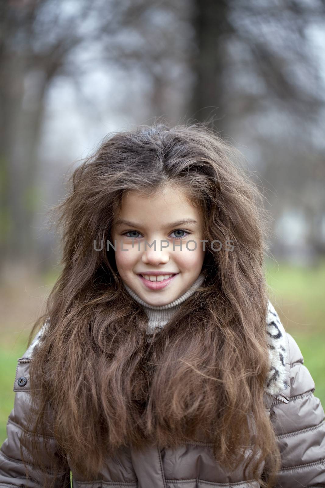 Autumn portrait of a beautiful young girl on the street