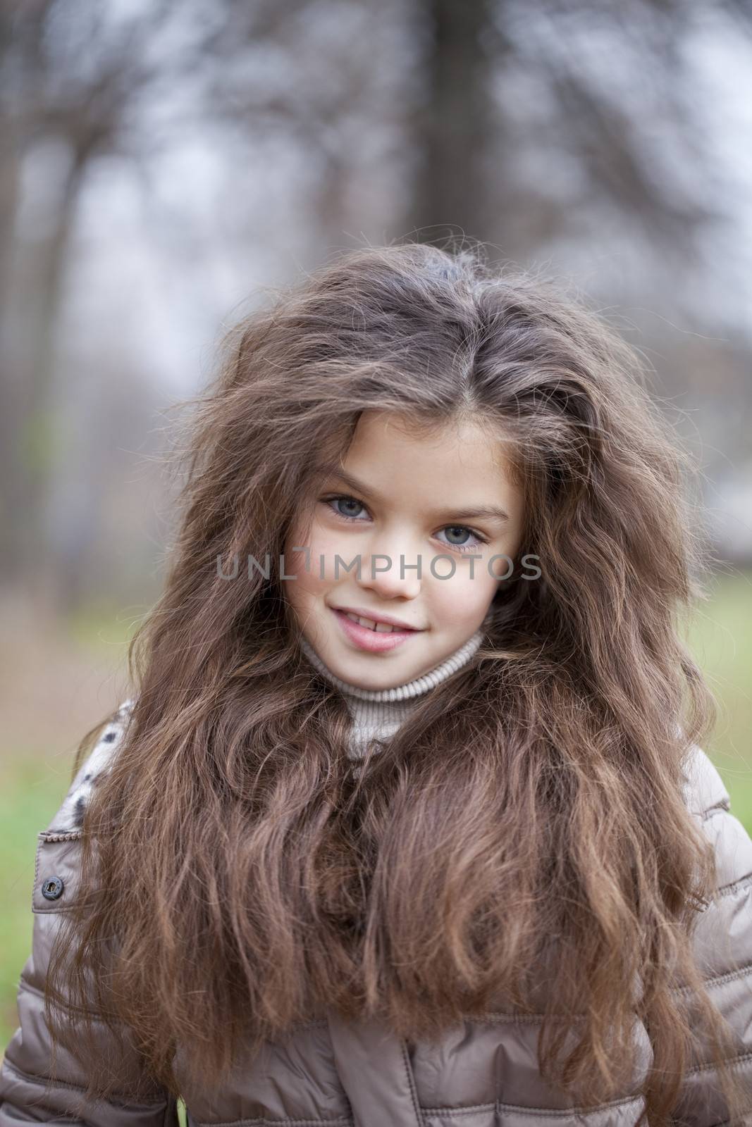 Autumn portrait of a beautiful young girl on the street