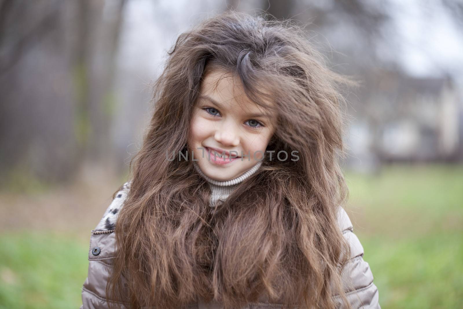 Autumn portrait of a beautiful young girl on the street