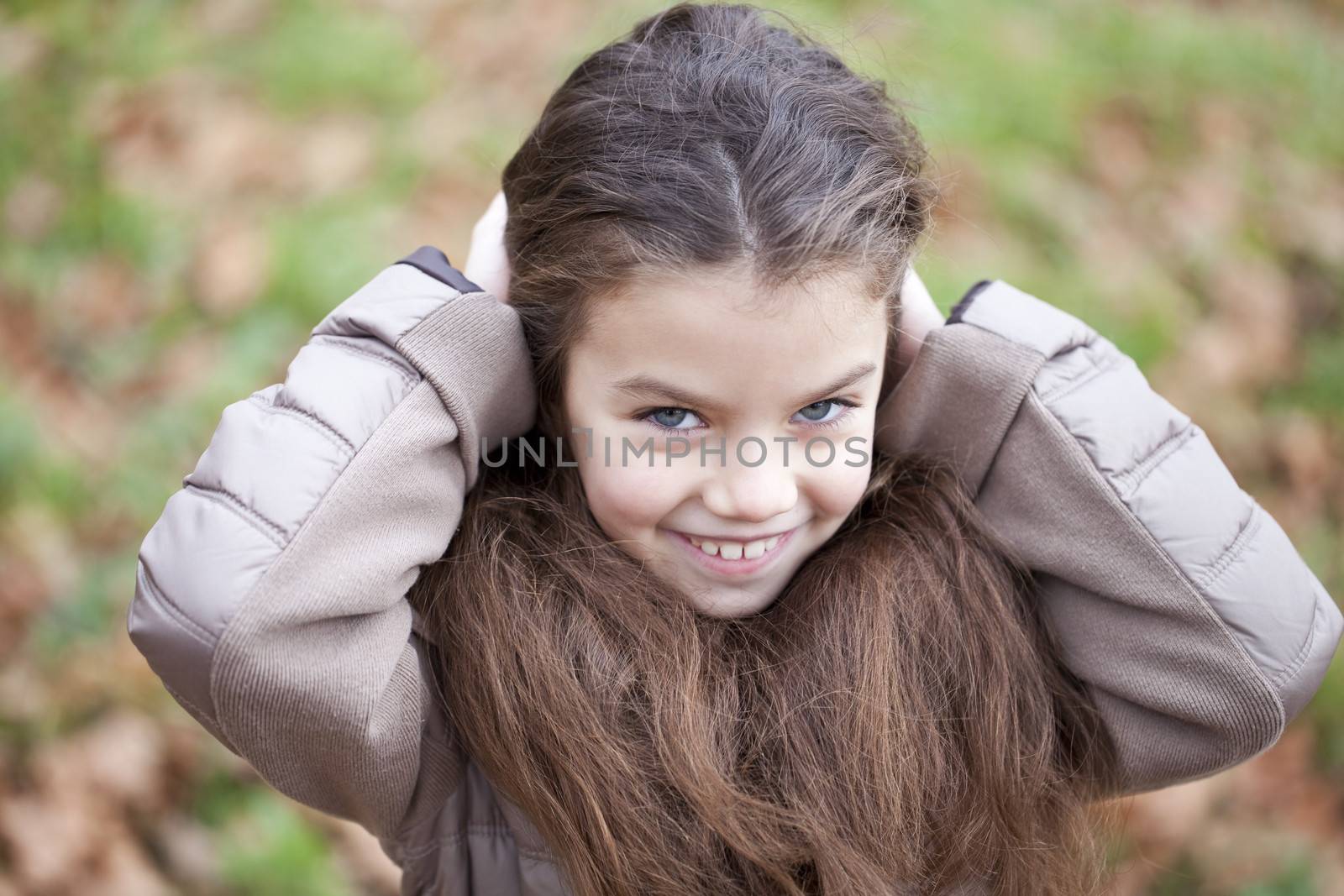 Autumn portrait of a beautiful young girl on the street
