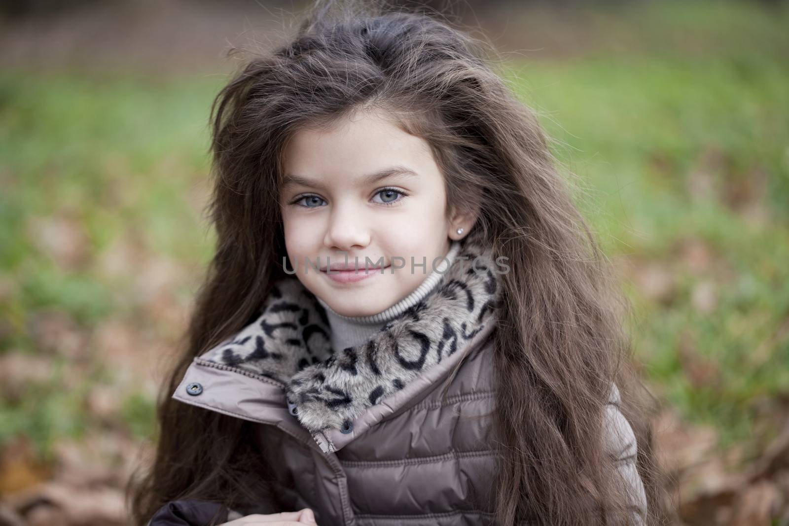 Autumn portrait of a beautiful young girl on the street