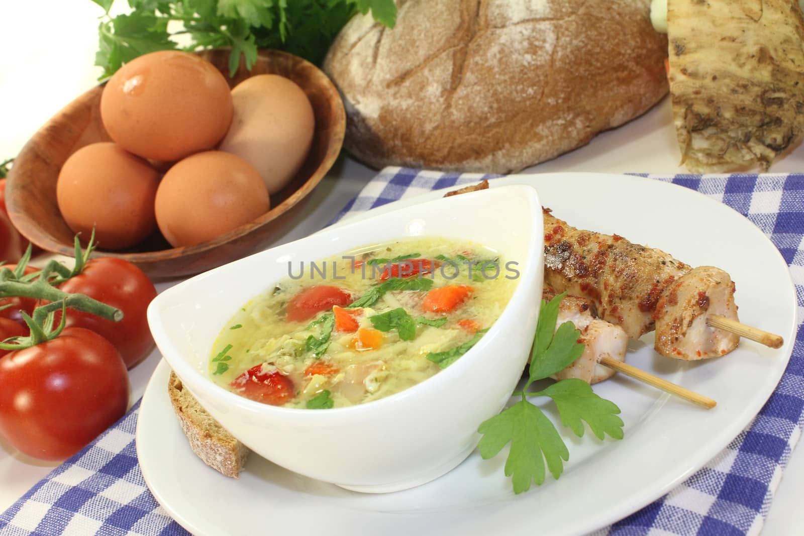 a chicken soup with egg and parsley