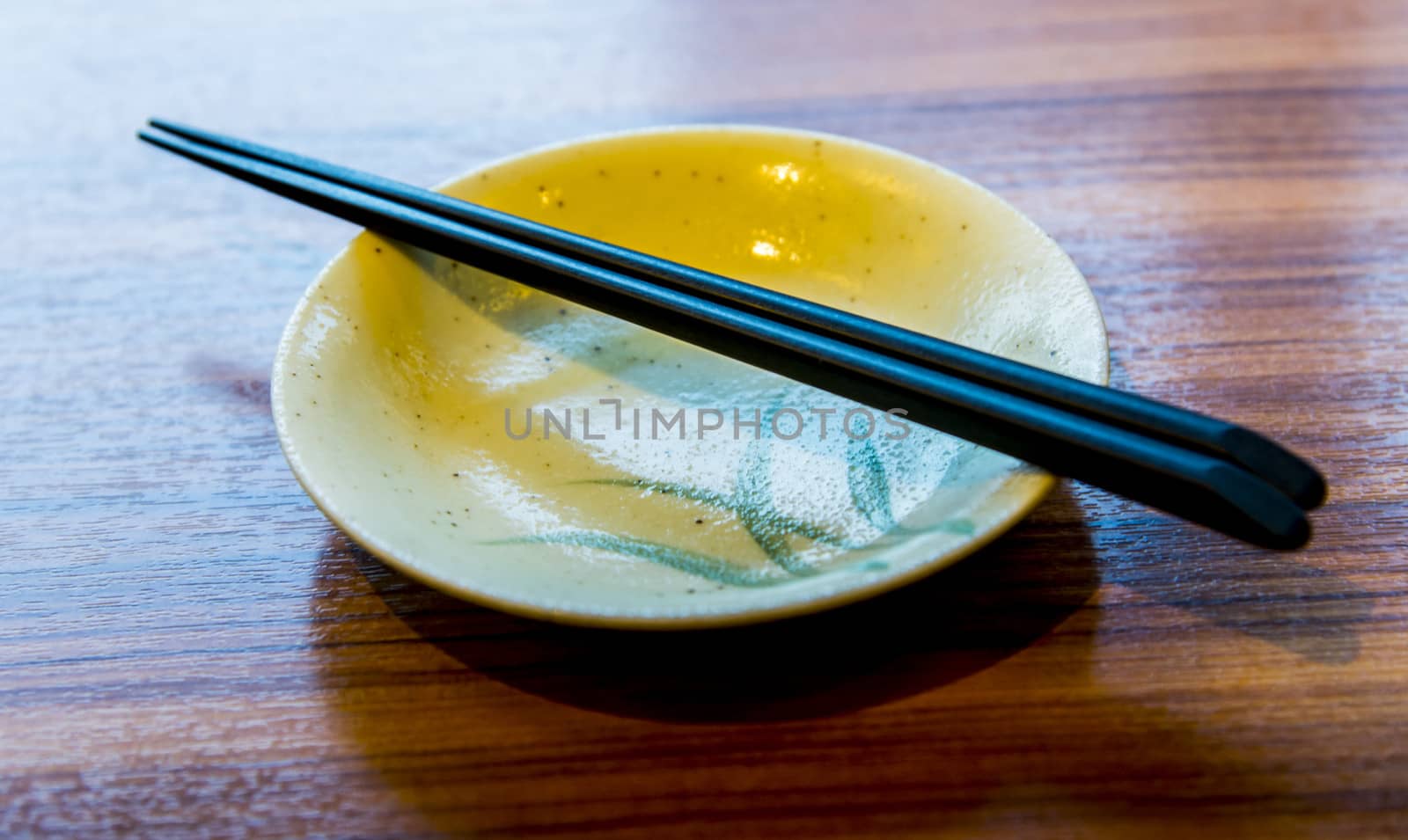 Ceramic bowl and chopsticks by gjeerawut