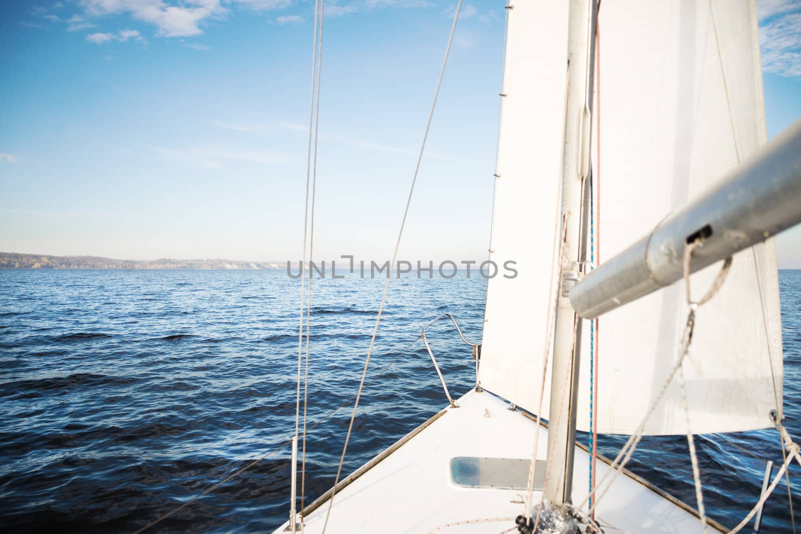 The white yacht sailing towards the sunset