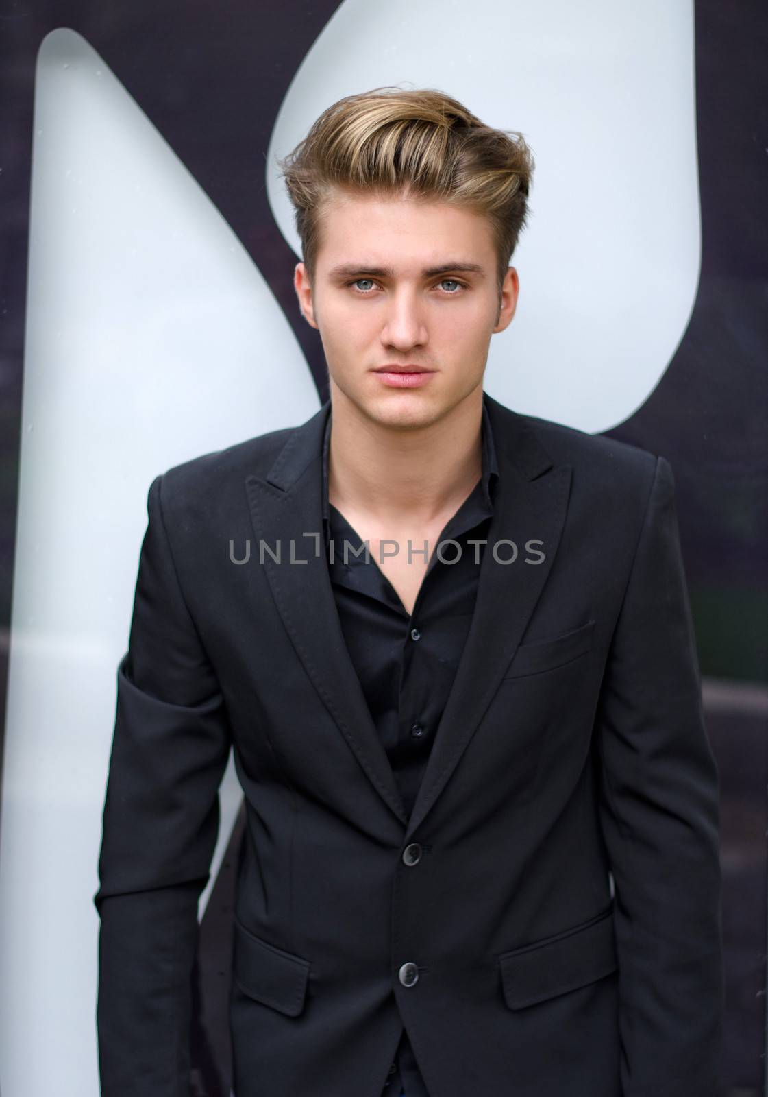 Attractive blond young man in shirt and jacket by artofphoto