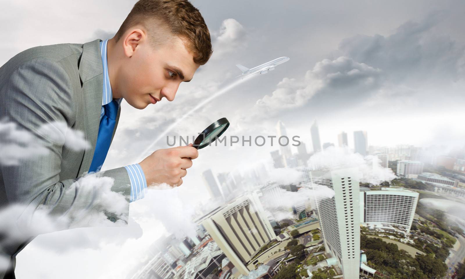 Image of businessman examining objects with magnifier