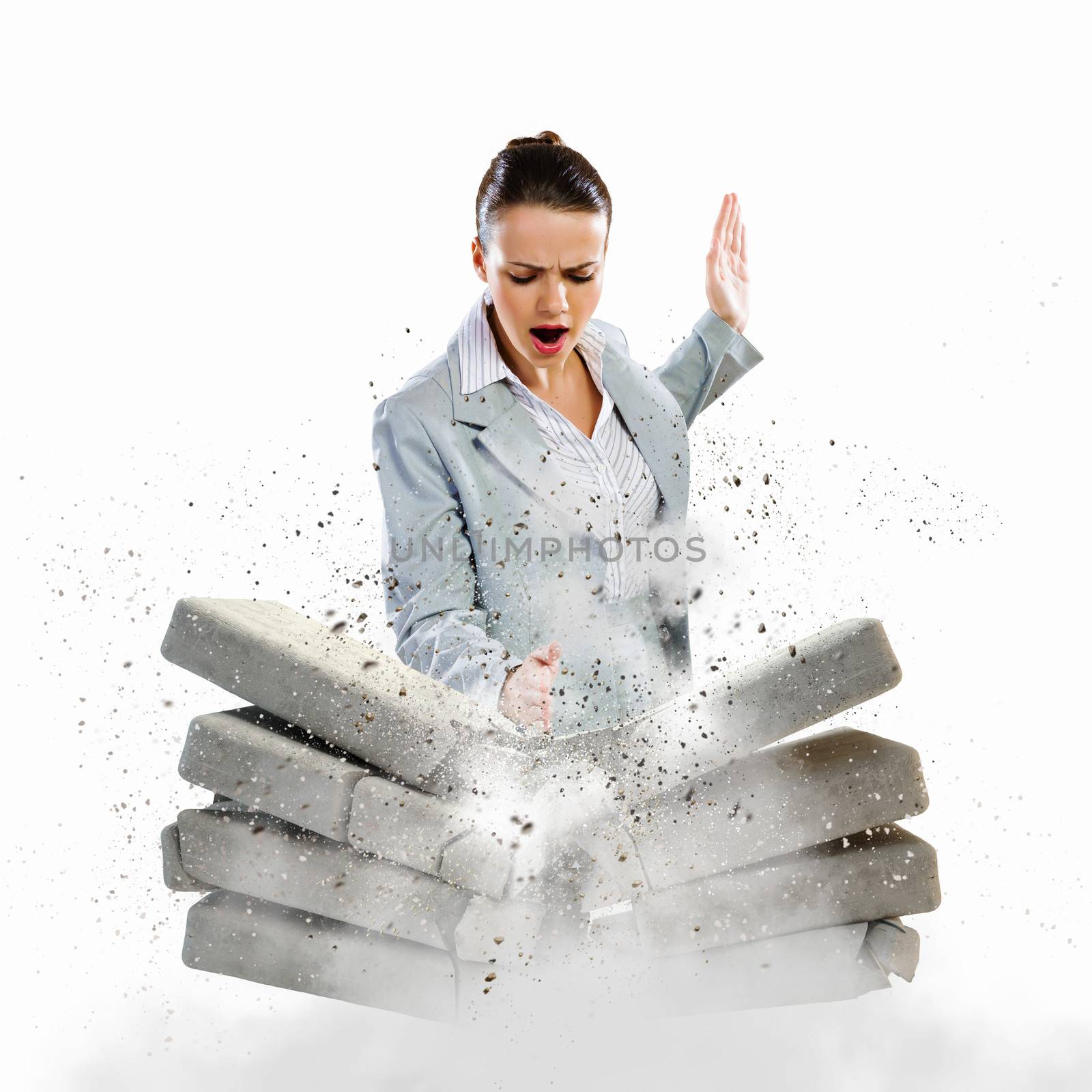 Image of businesswoman breaking bricks with hand