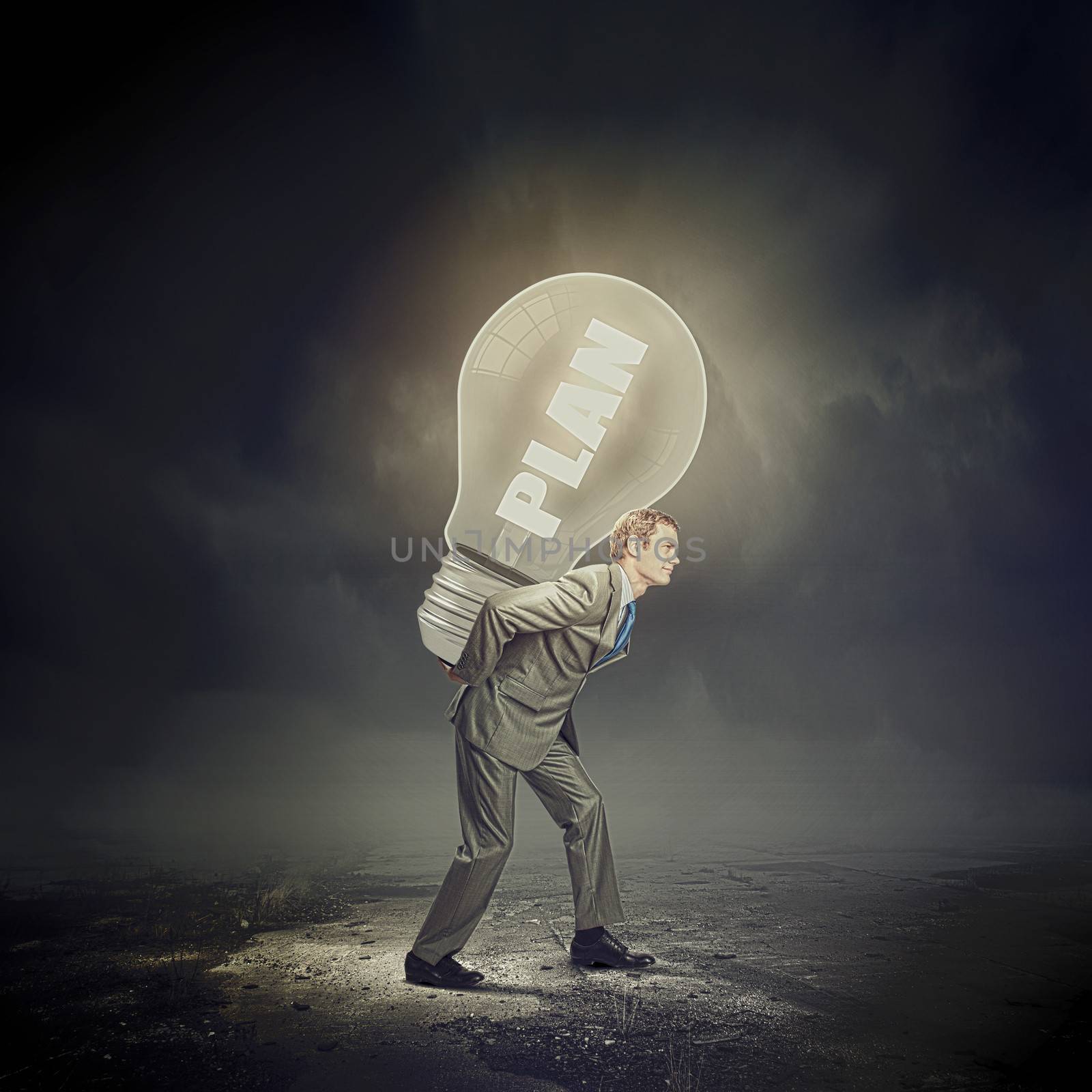 Image of businessman carrying bulb on back. New idea