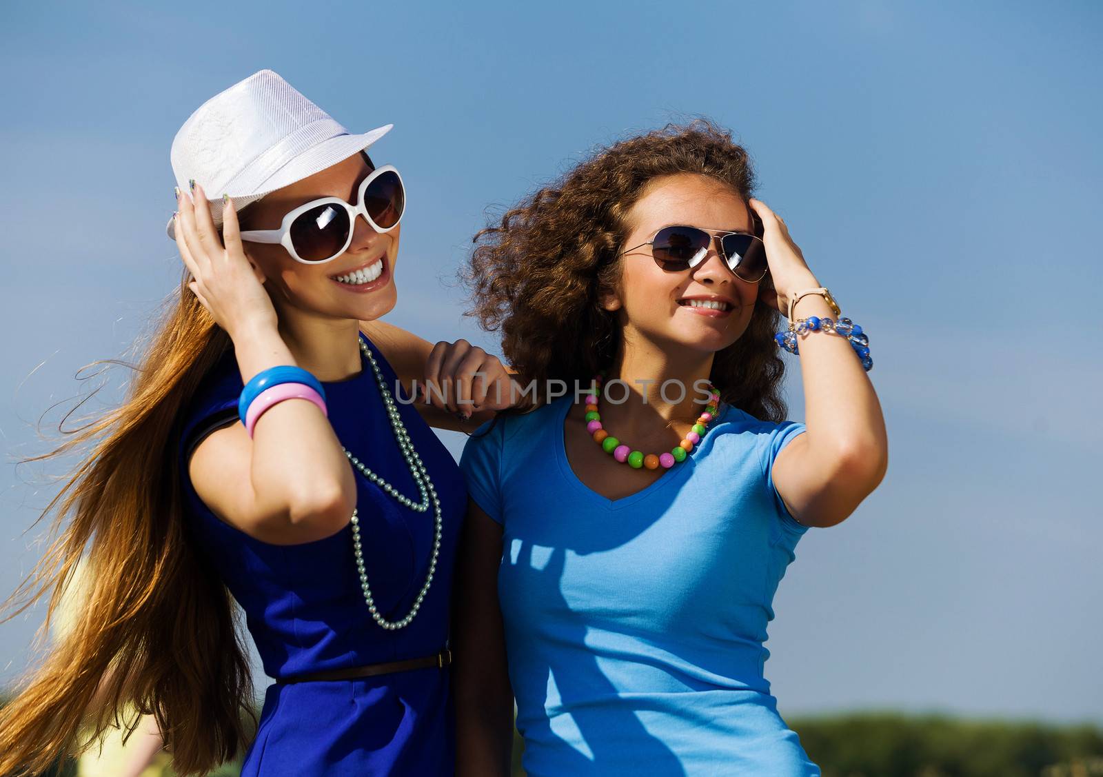 Attractive young women having fun outdoors. Summer vacation