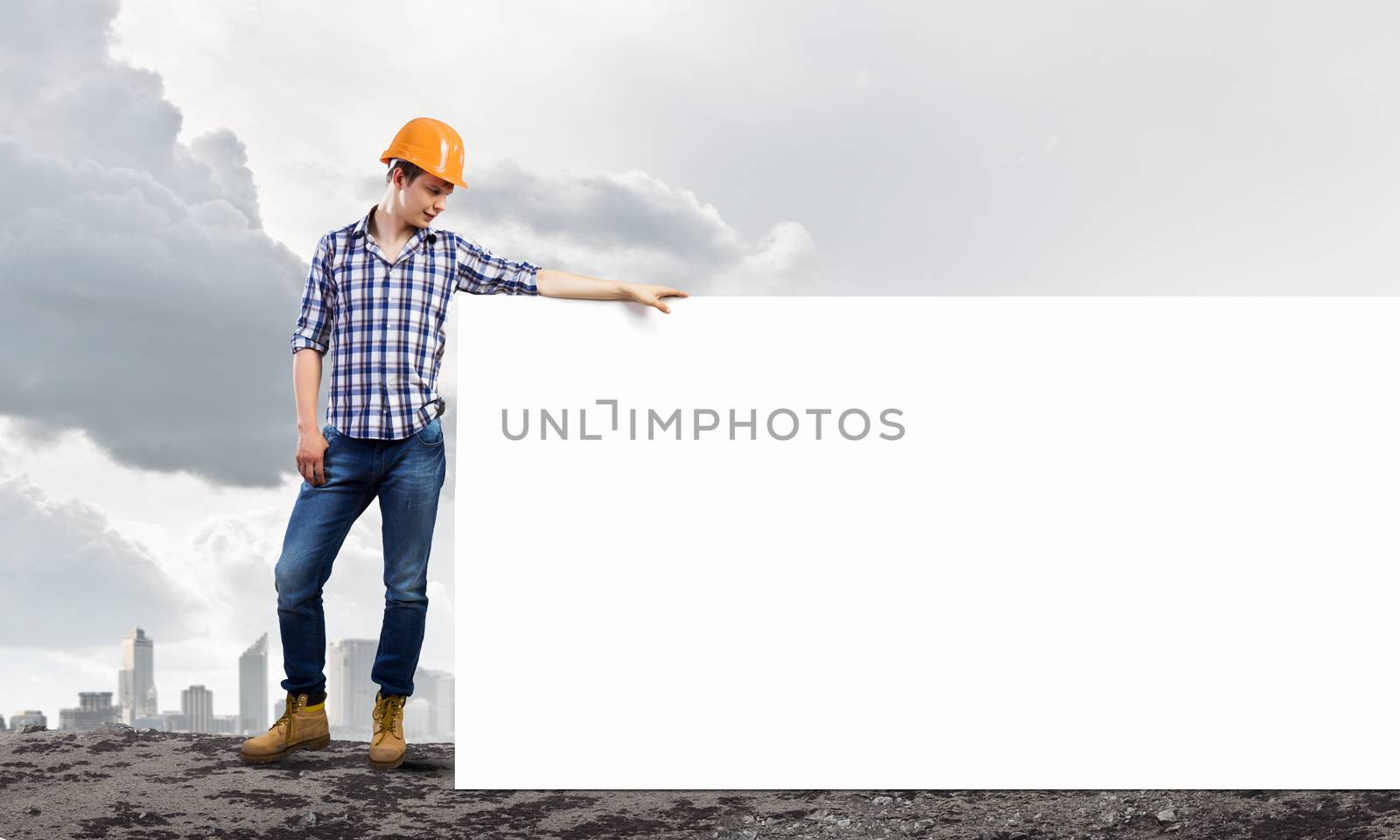 Image of man engineer in helmet with blank banner