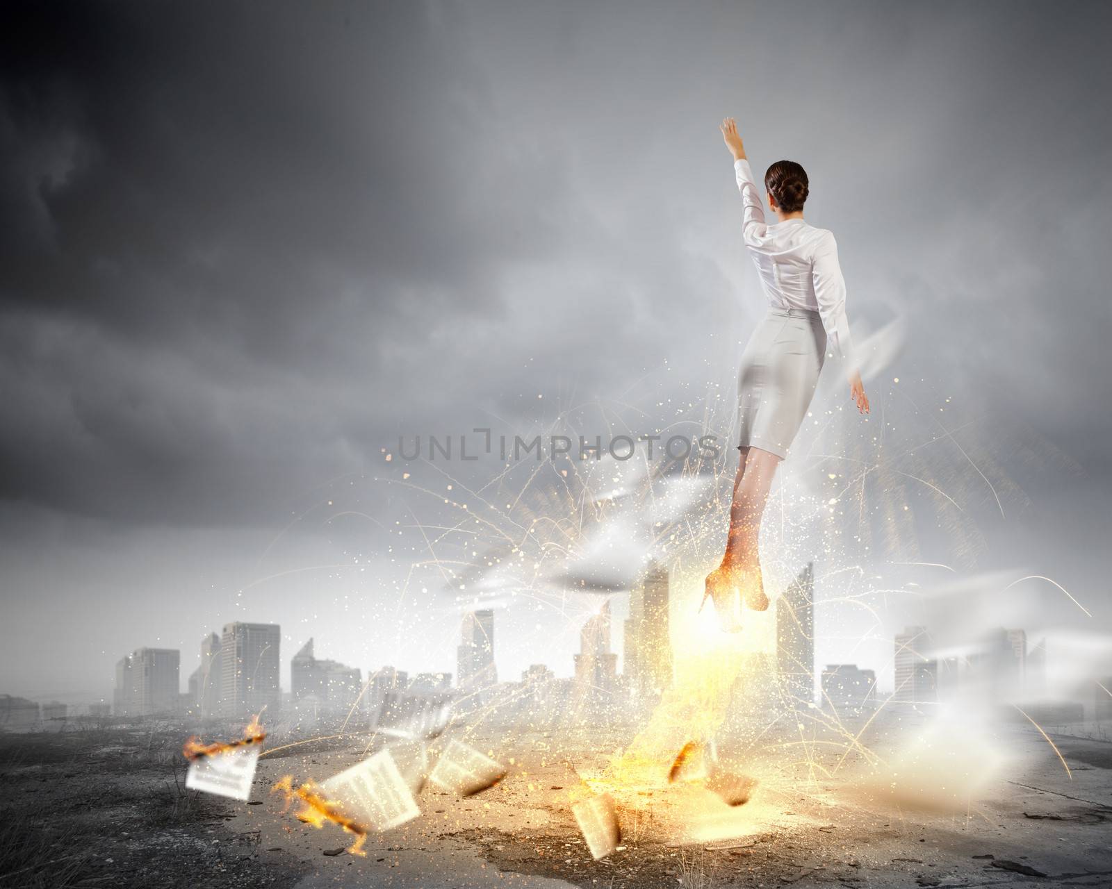 Image of businesswoman flying up into sky