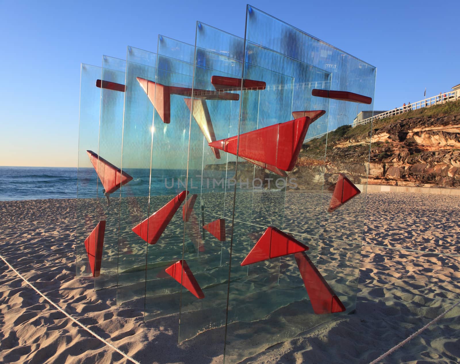 Bondi Beach, Australia - November 3,  2013: Sculpture By The Sea, Bondi 2013. Annual cultural event that showcases emerging artists from around the world  Sculpture titled 'Moment of Clarity' by David Hashimoto (NSW).  Medium toughened glass, fibreglass, steel.  Price $28000