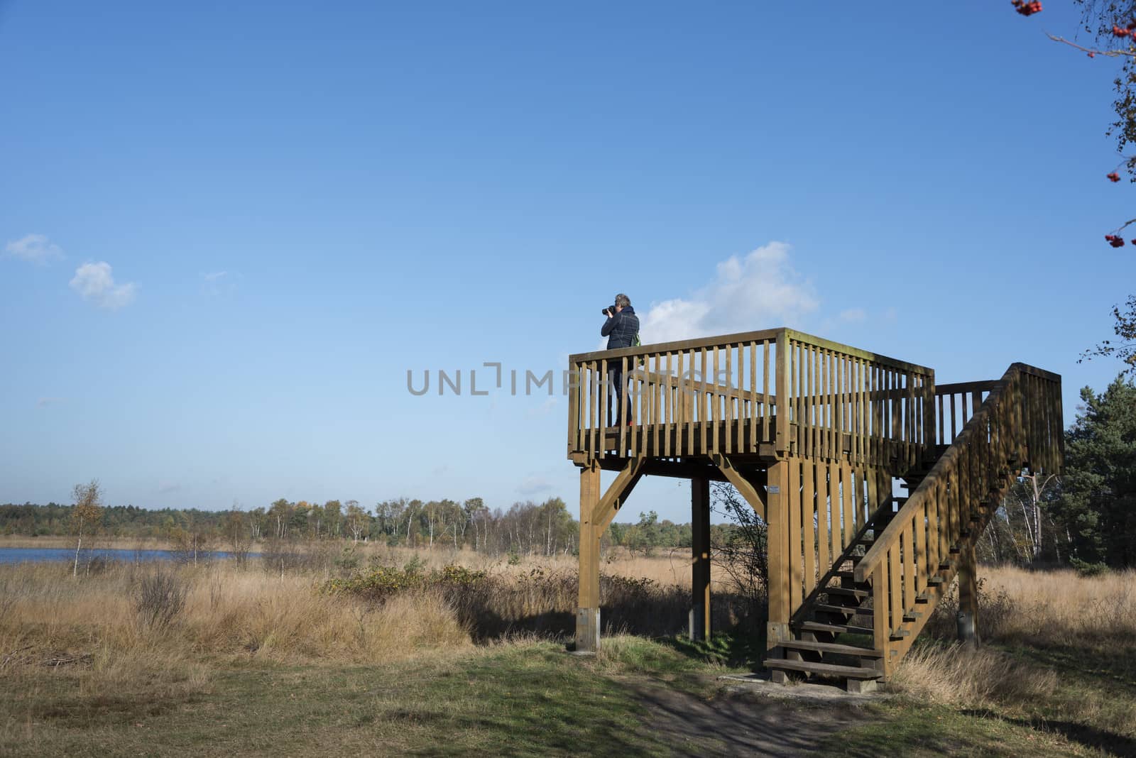 woman making photos from observation post at the gilderhauser venn nature area