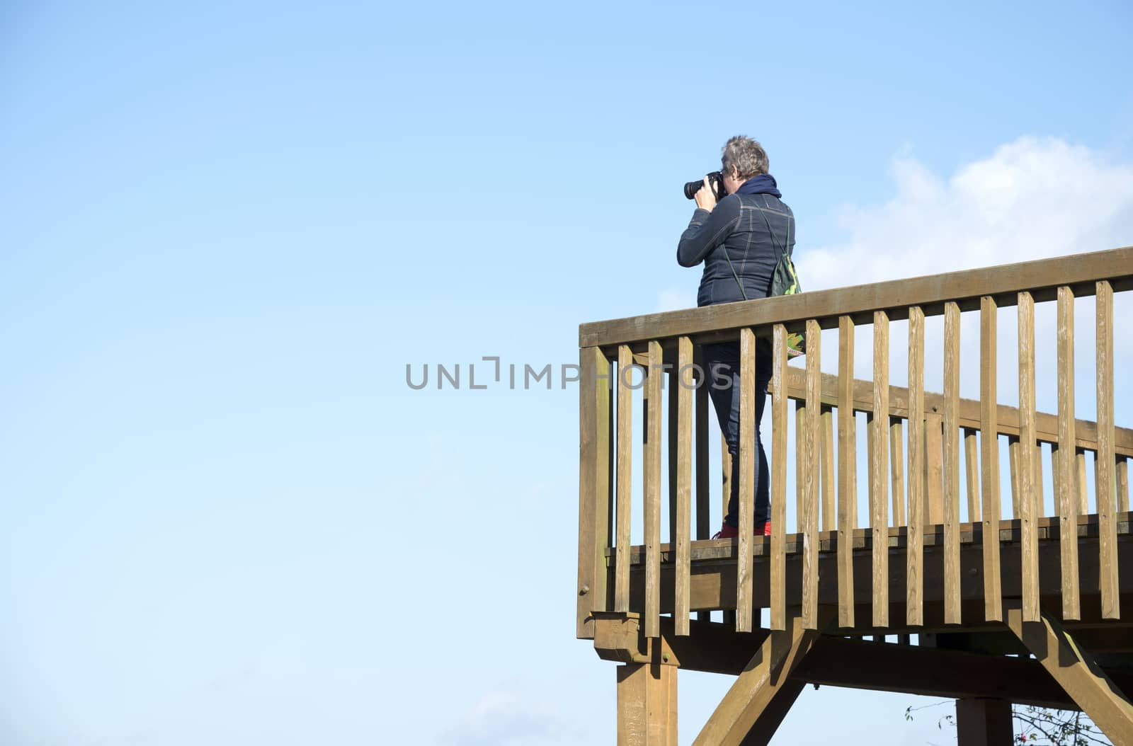 aldult woman making photos from observation post