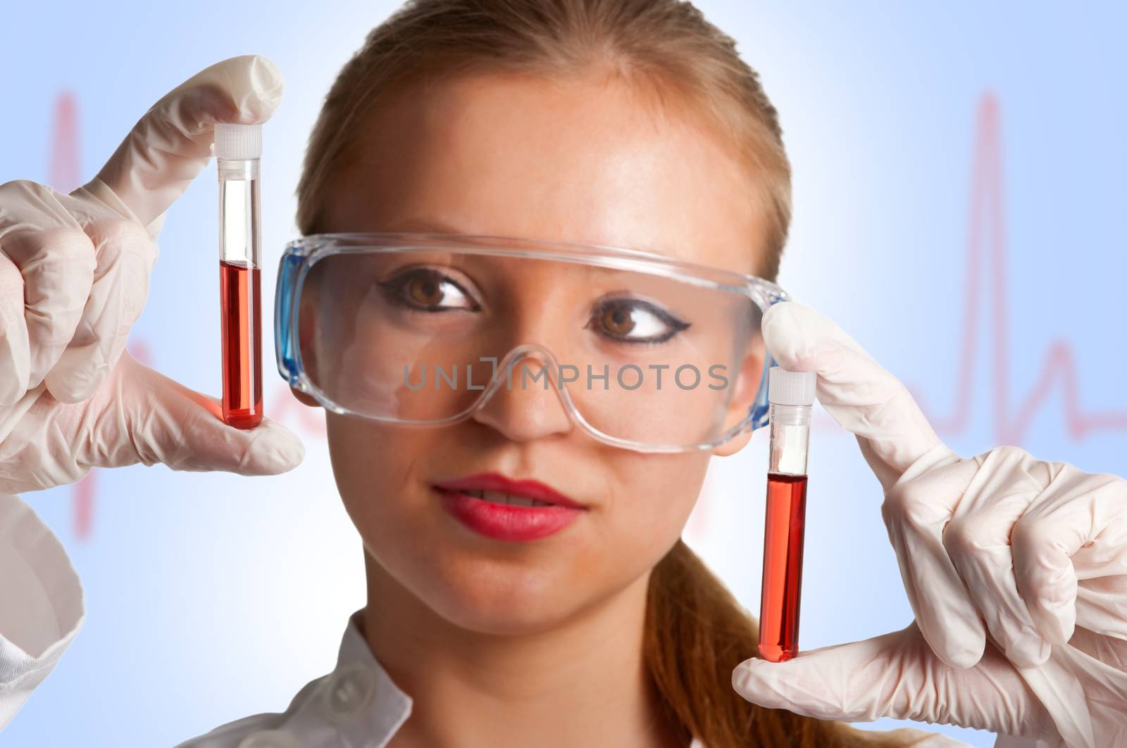 Women looking at laboratory test tubes with an EKG graph behing her