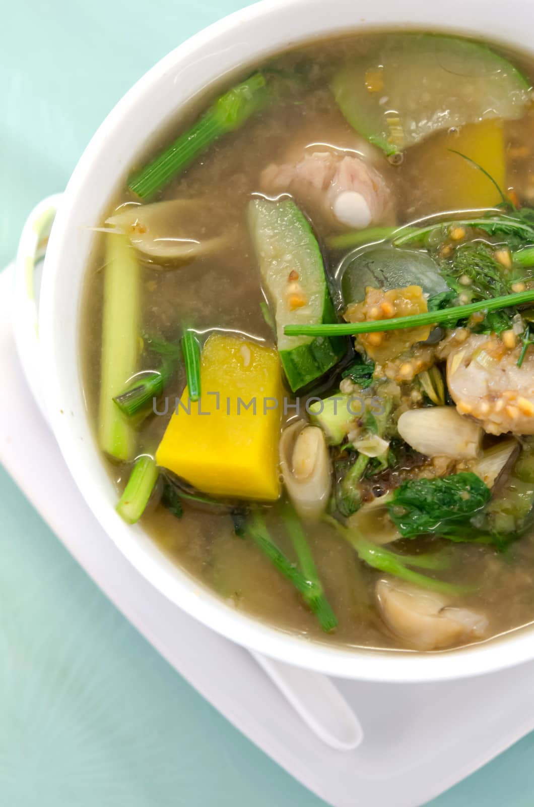 close up a savoury thick soup made from pork , spices and vegetables