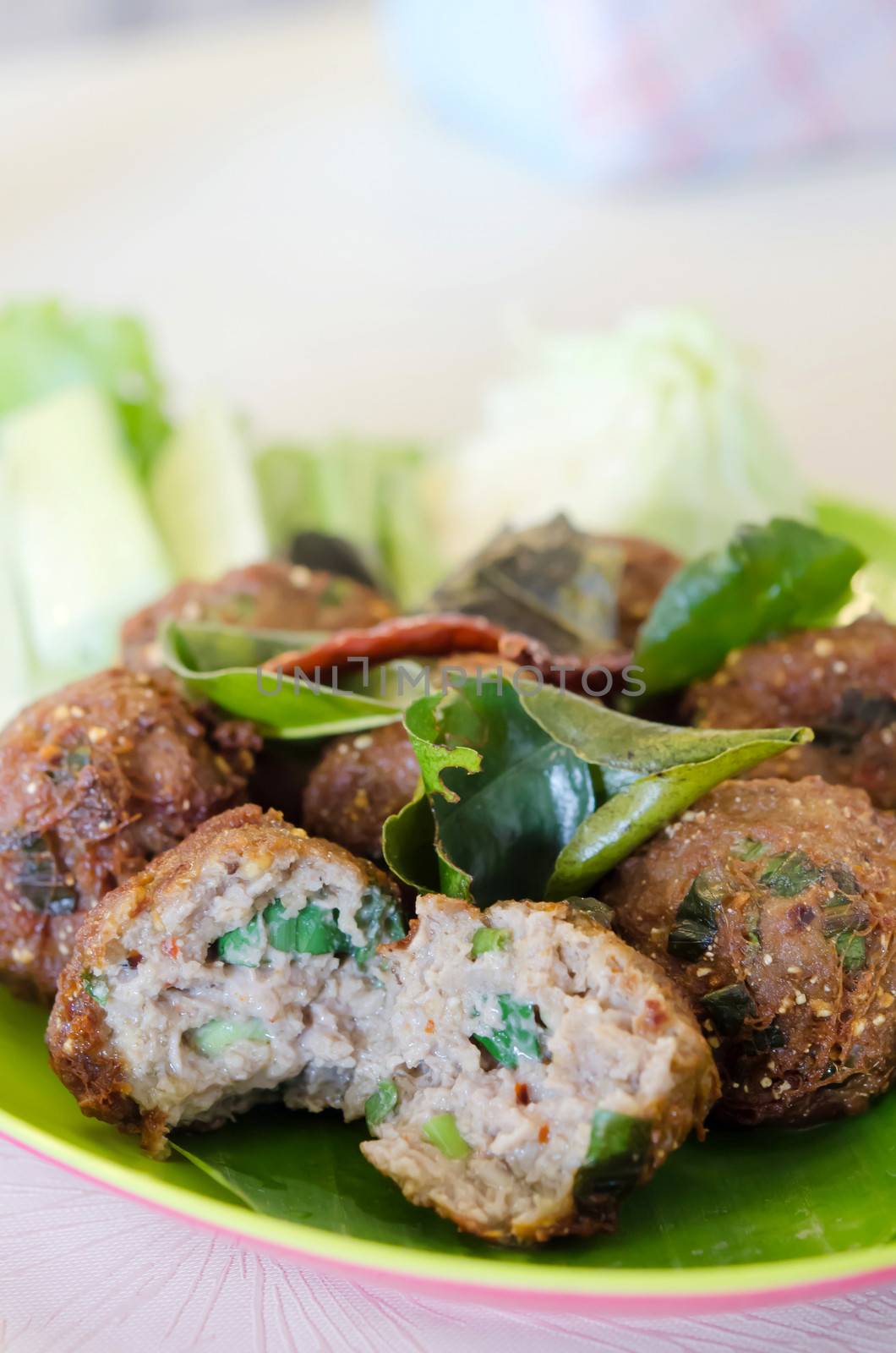 meatballs served with fried  bergamot leaves and fresh vegetable