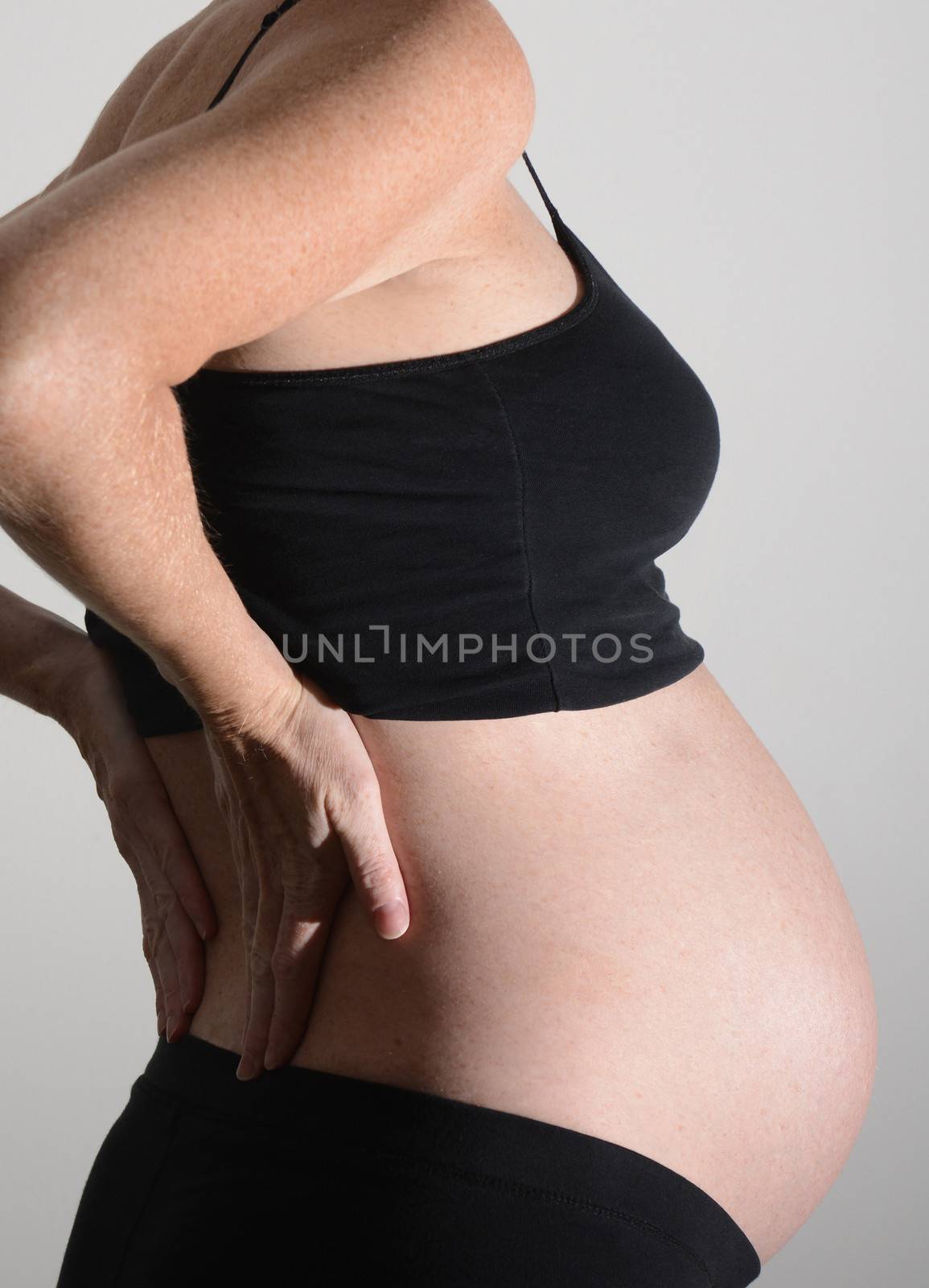 pregnant woman and back pain with hands on back