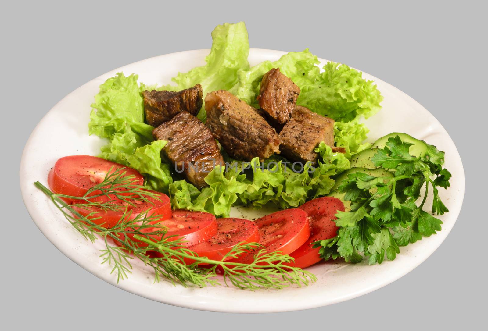 Stew with vegetables on the white plate. Isolated on the gray background.