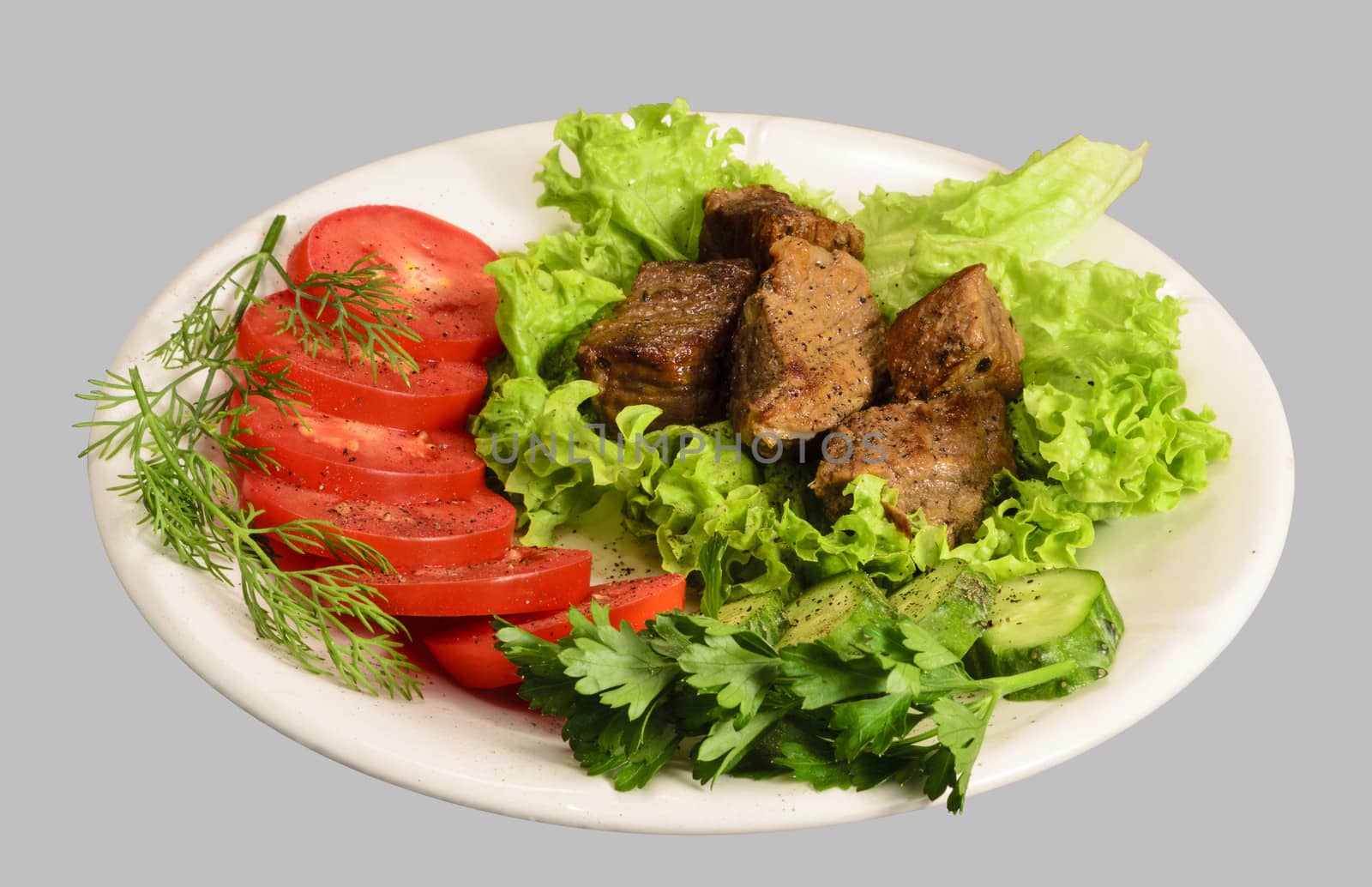 Stew with vegetables on the white plate. Isolated on the gray background.