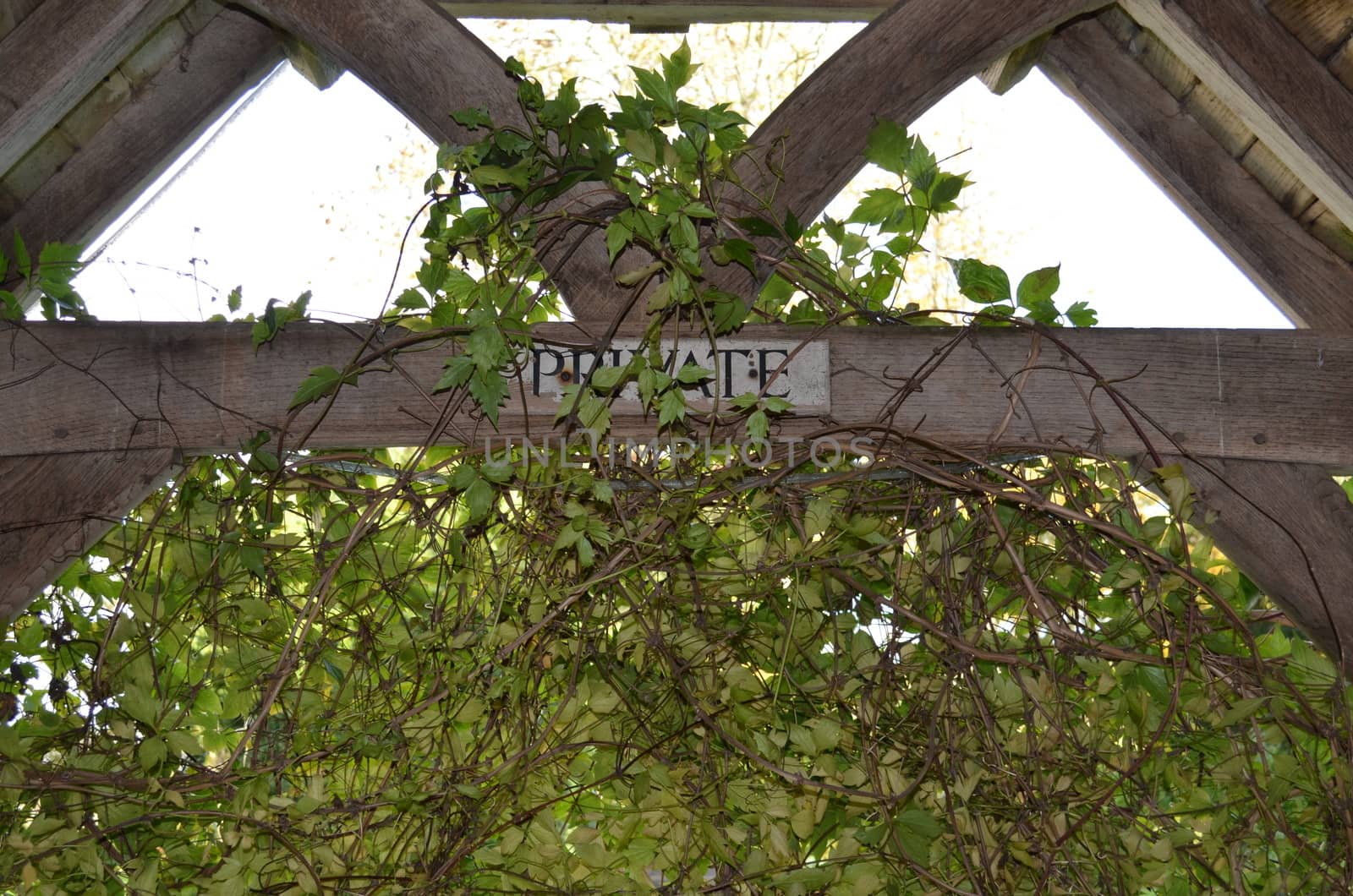 Neglected wooden private sign on a gateway beam.