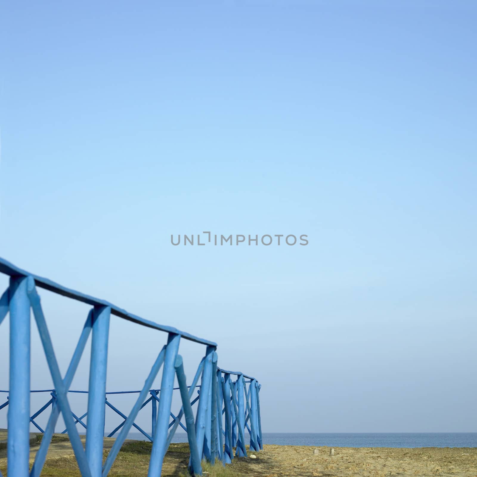 Blue wooden fence near the sea