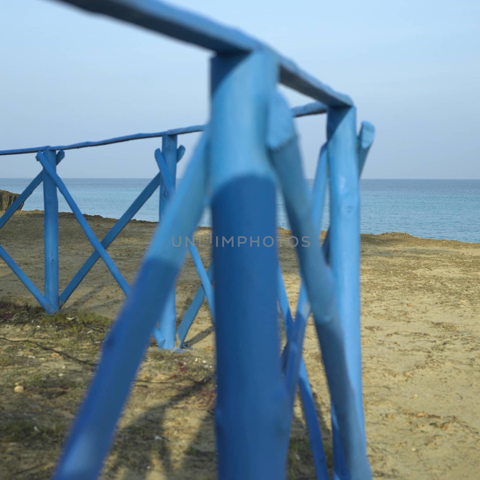 Blue wooden fence near the sea