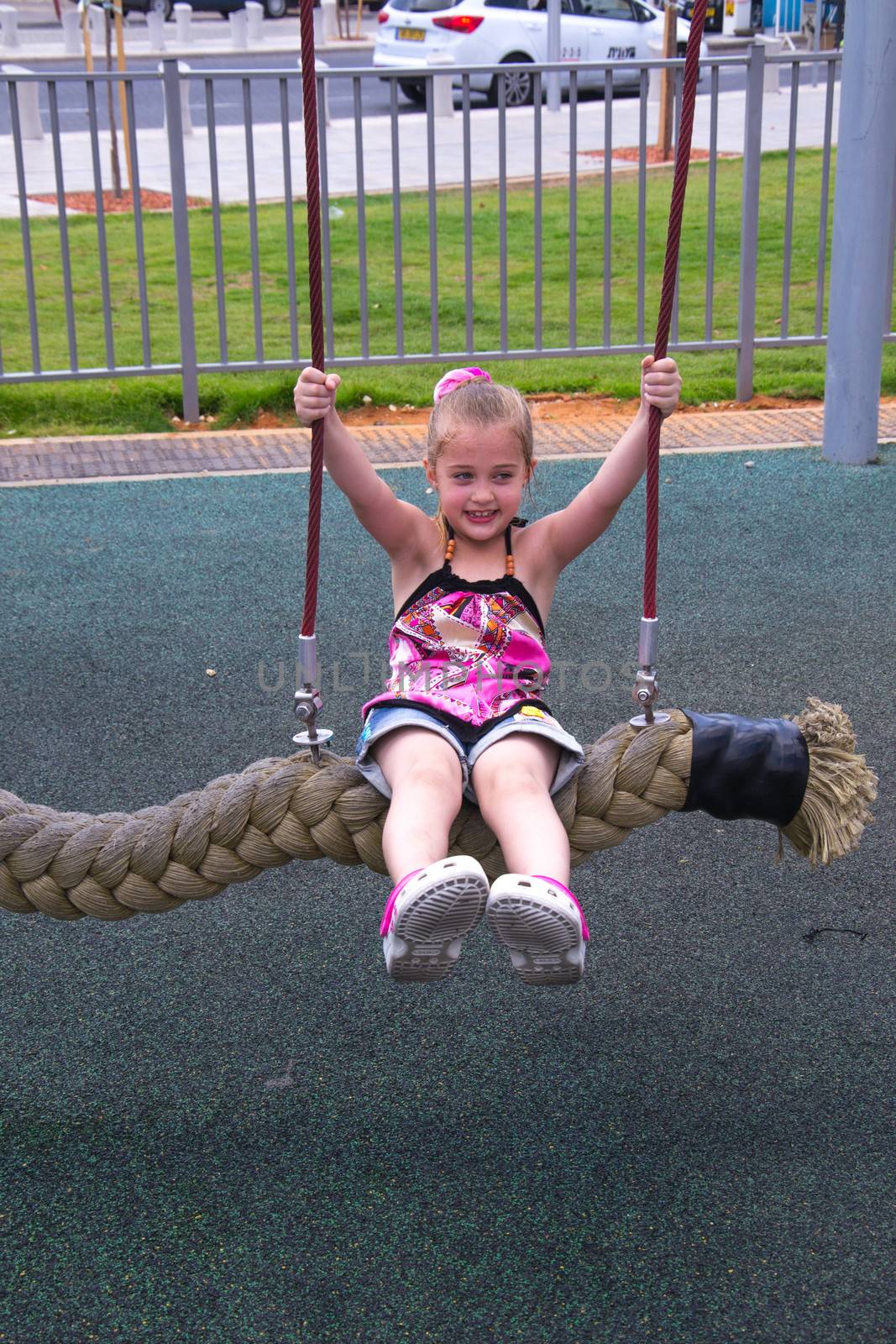 Beautiful girl play outdor on swing